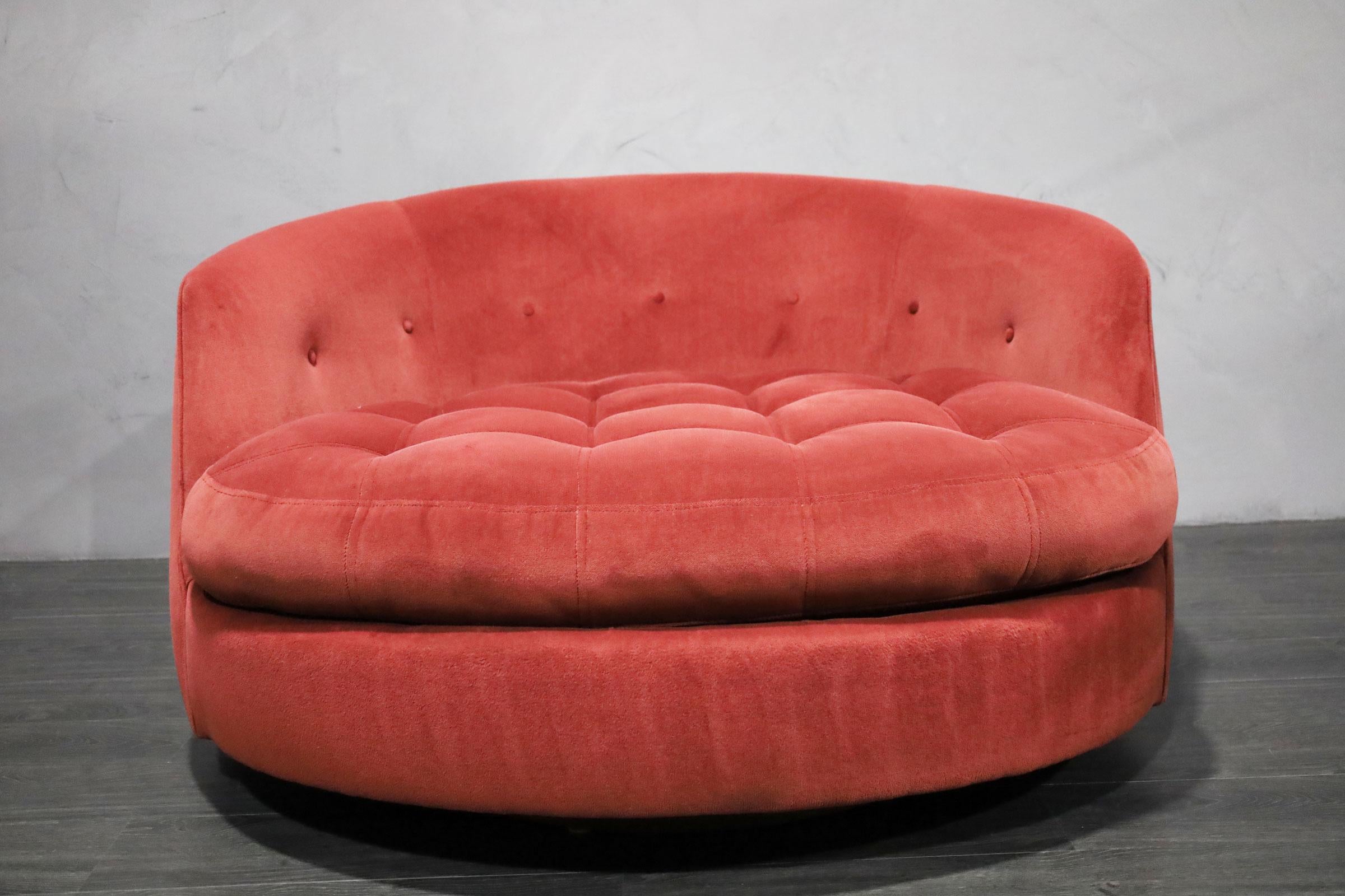 The chair people love to lounge in by Milo Baughman. His iconic large tub chair with swivel base. This one is in a raspberry microfiber that is in very good condition. It can also be reupholstered.