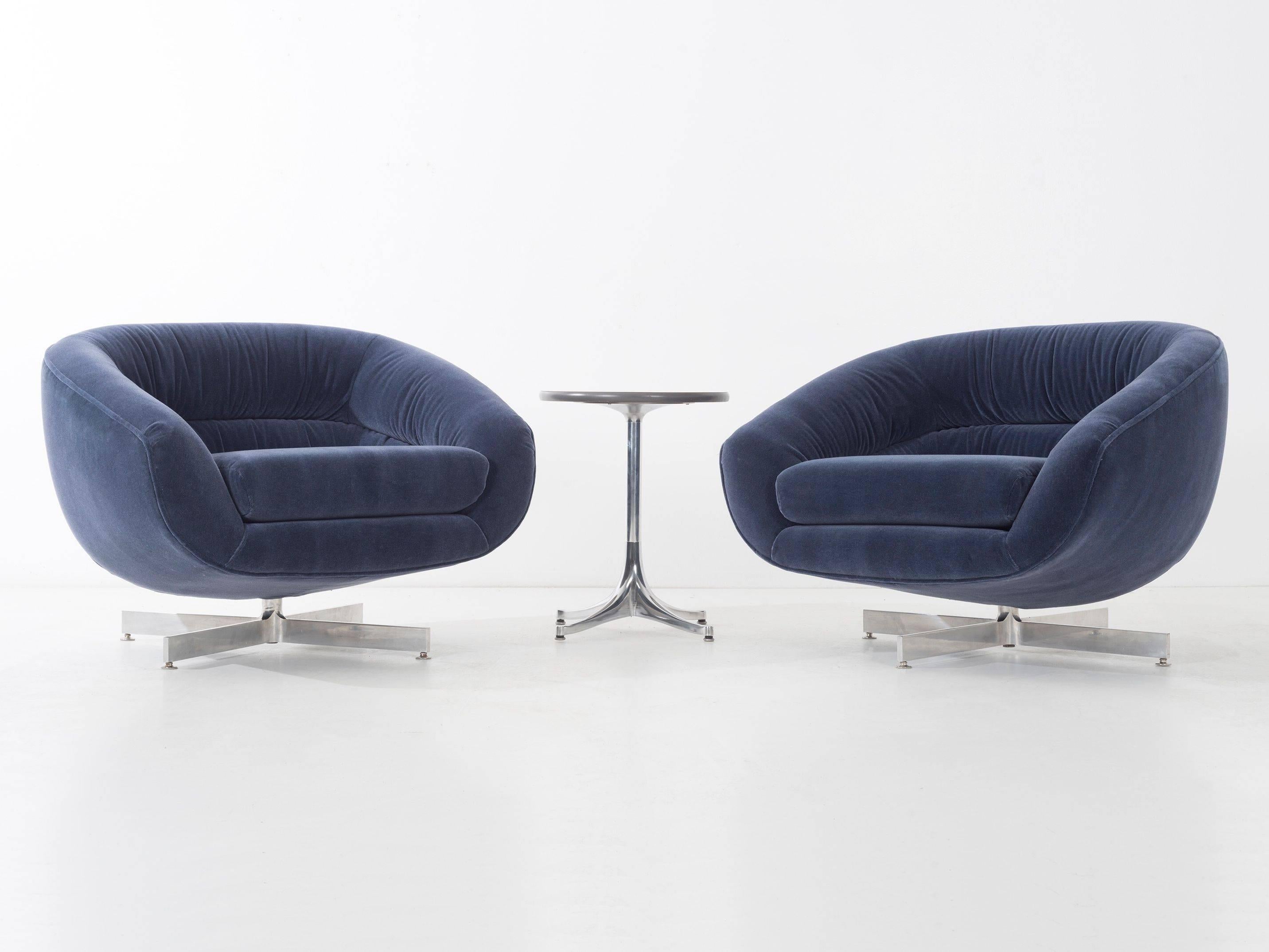 Channeled tub chairs. Features tilt swivel solid aluminum bases. Upholstered in navy blue mohair.