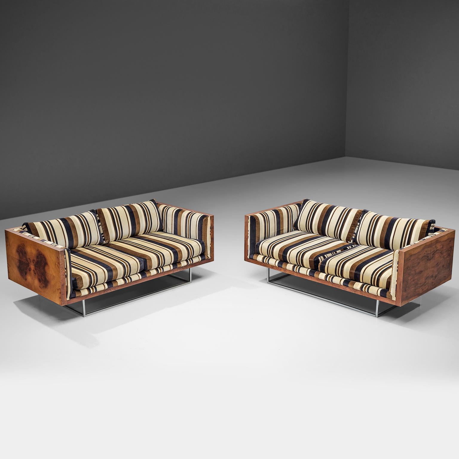 Milo Baughman for Thayer Coggin sofa in rosewood and striped velvet, United States, 1970s. 

These sofas made with rosewood sides don't go unnoticed as it attracts attention through it's stripy and different colored upholstery. These tuxedo sofas