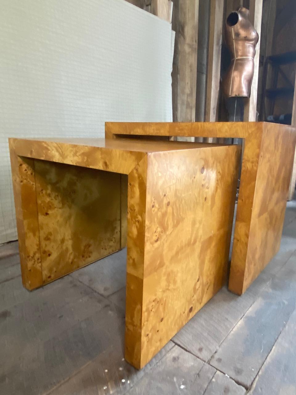 Set of classic mid century modern burl wood waterfall nesting tables by Hekman for their Wind Row collection, circa 1977. 
 Bourbon colored burl wood veneer with recessed interior side panels. 
 Large table 28” W X 24” H X 20” D
 Small table 22.5” W