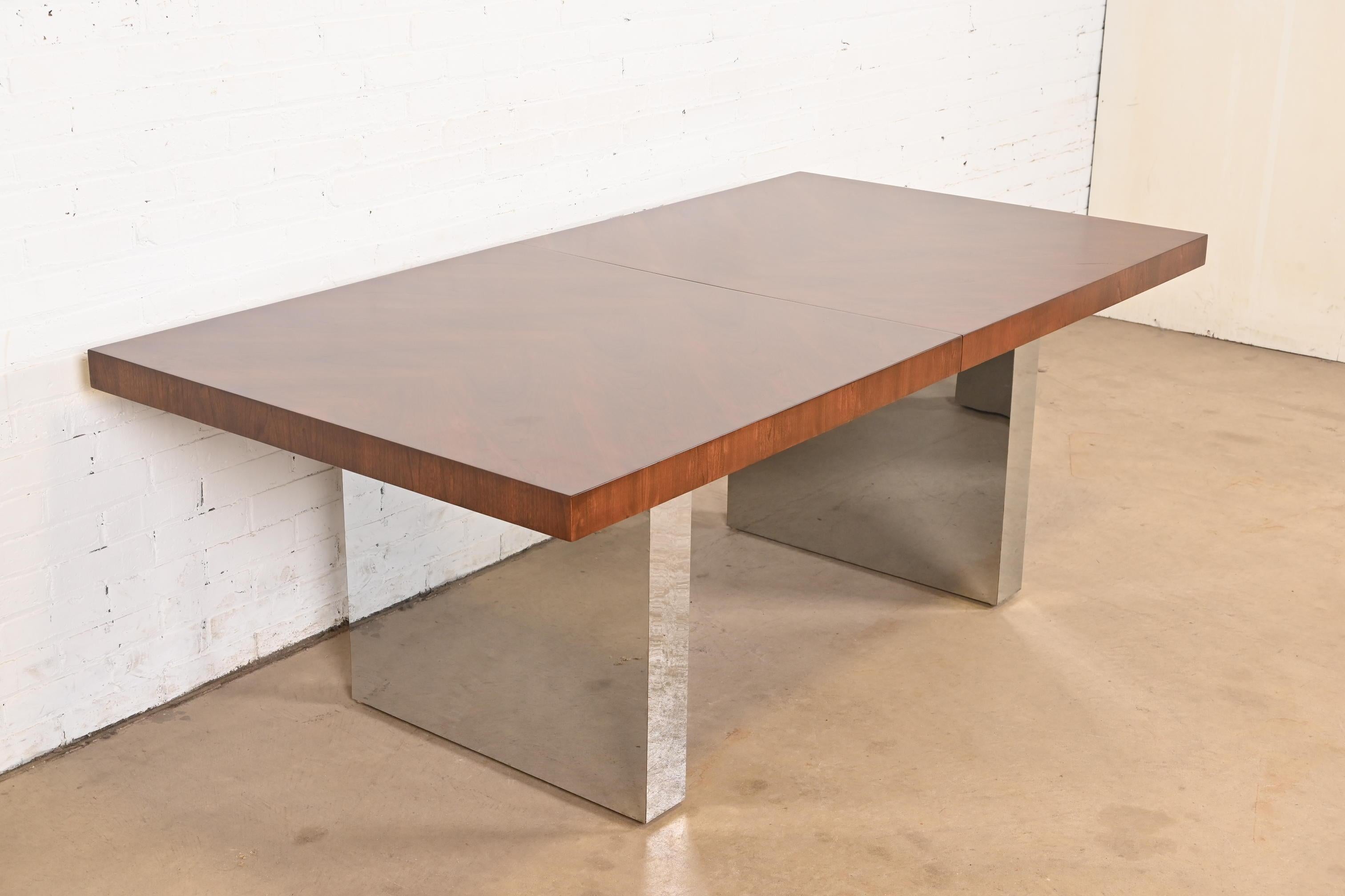 An exceptional Mid-Century Modern double pedestal dining table

By Milo Baughman for Thayer Coggin

USA, 1970s

Stunning book-matched walnut top, with chrome slab pedestals.

Measures: 78