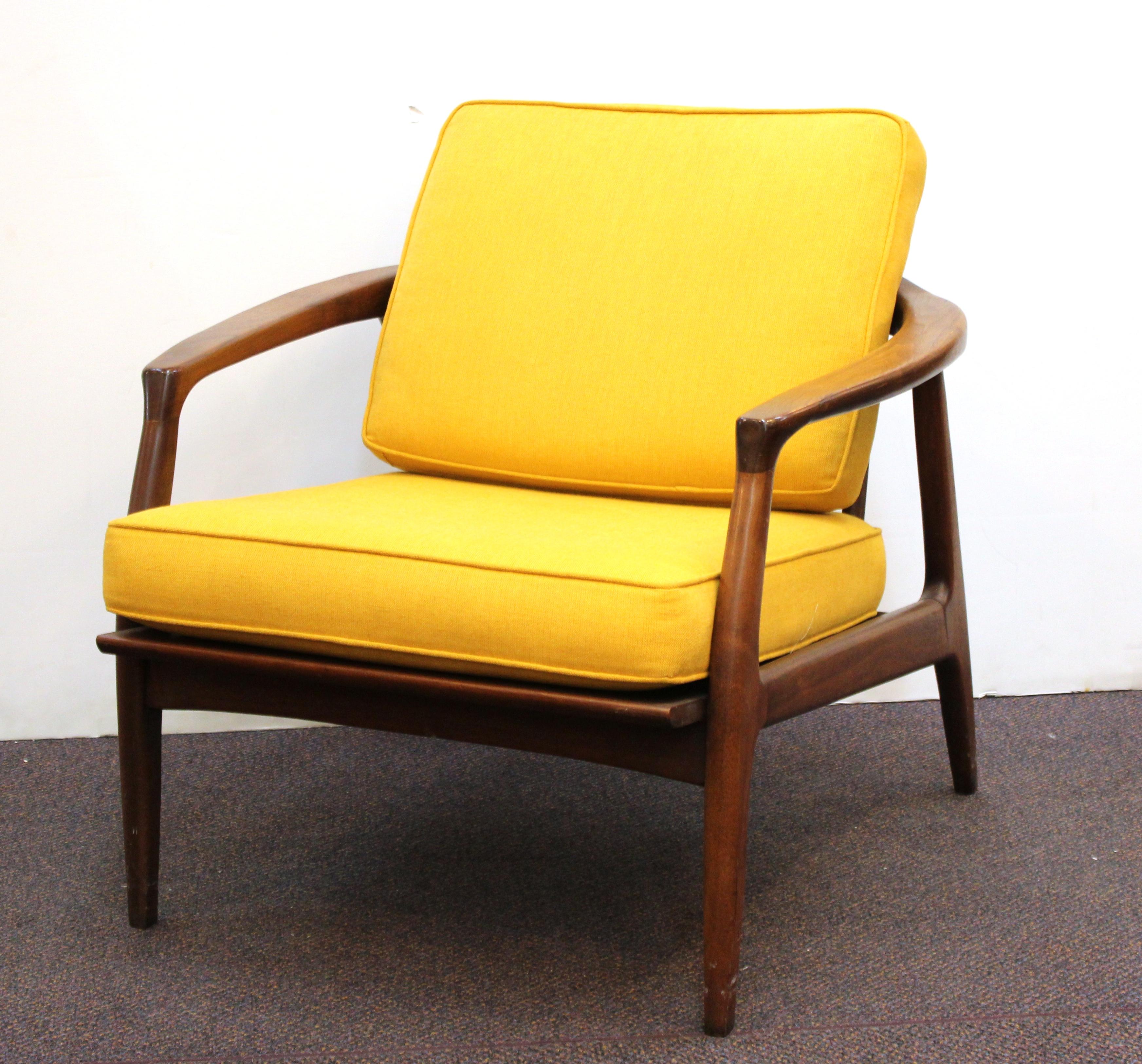 Pair of Mid-Century Modern lounge chairs designed by Milo Baughman for Thayer Coggin in the mid-20th century. The pair is made in wood and has upholstered seat and back cushion. Milo Baughman for Thayer Coggin label on the seat underneath cushion.