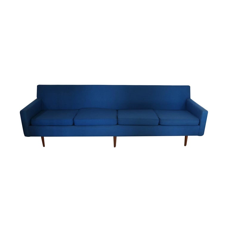 A very attractive four-seat sofa designed by Milo Baughman for Thayer Coggin. This is a fine example of Baughman early 1950s work. Distinctive early Mid-Century Modern design shows Danish influence. Features original electric cobalt blue upholstery,