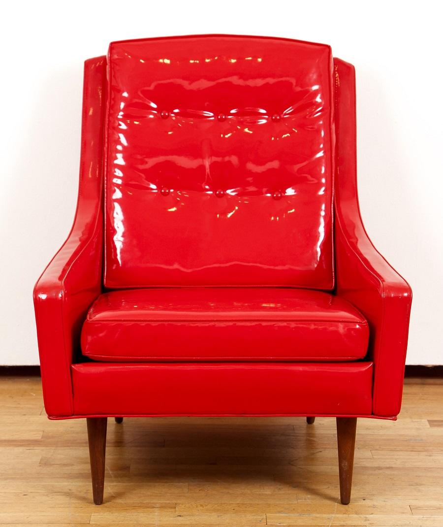 Milo Baughman for Thayer Coggin red vinyl lounge chair. The chair has walnut legs, nice mid century modern lines, and angled tapered rear legs. 


 