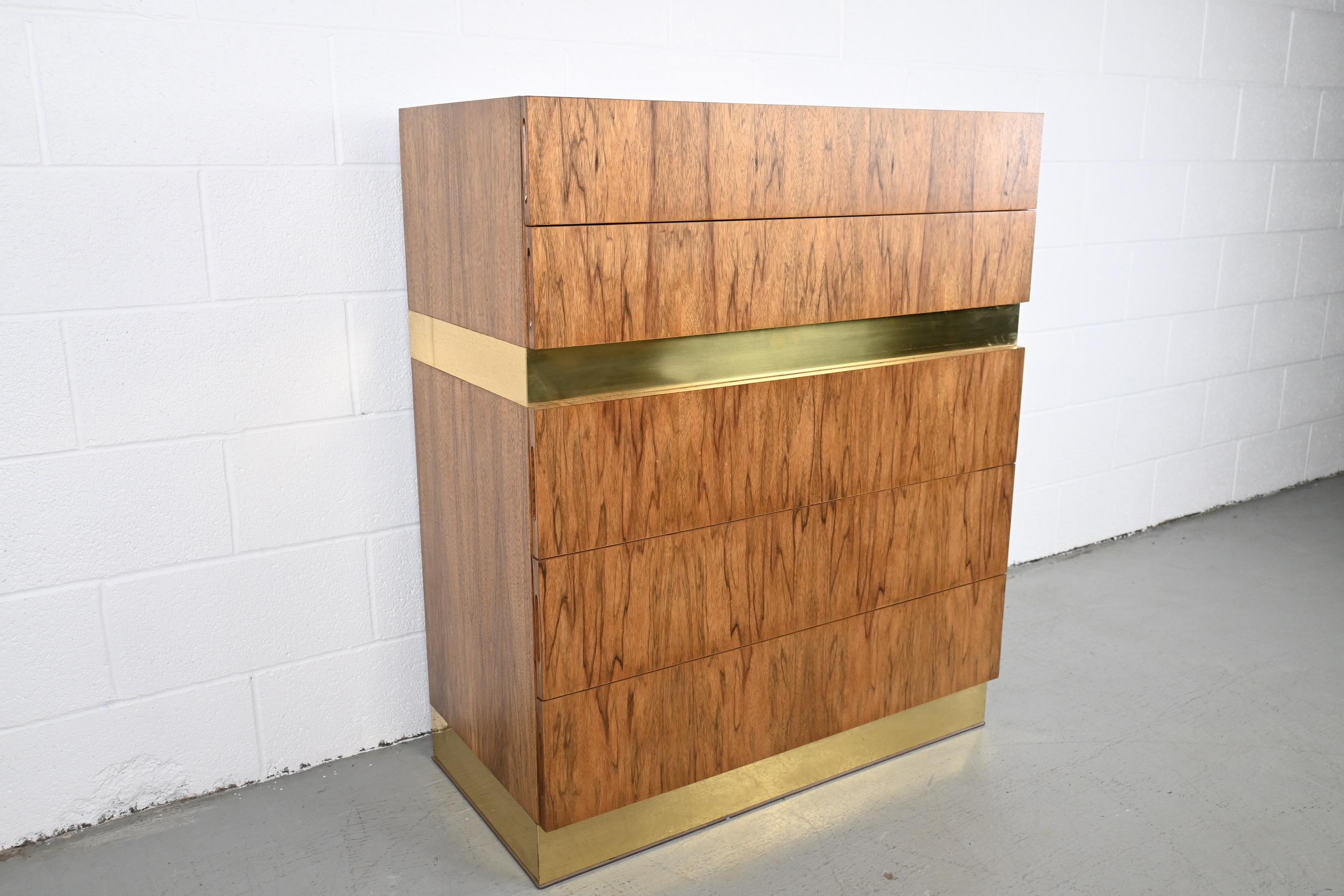 Milo Baughman for Thayer Coggin rosewood and brass five drawer highboy

Thayer Coggin, USA 1970s

Measures: 36 Wide x 18 Deep x 43.25 High

Mid-Century Modern rosewood five drawer highboy dresser with brass accents.

Professionally