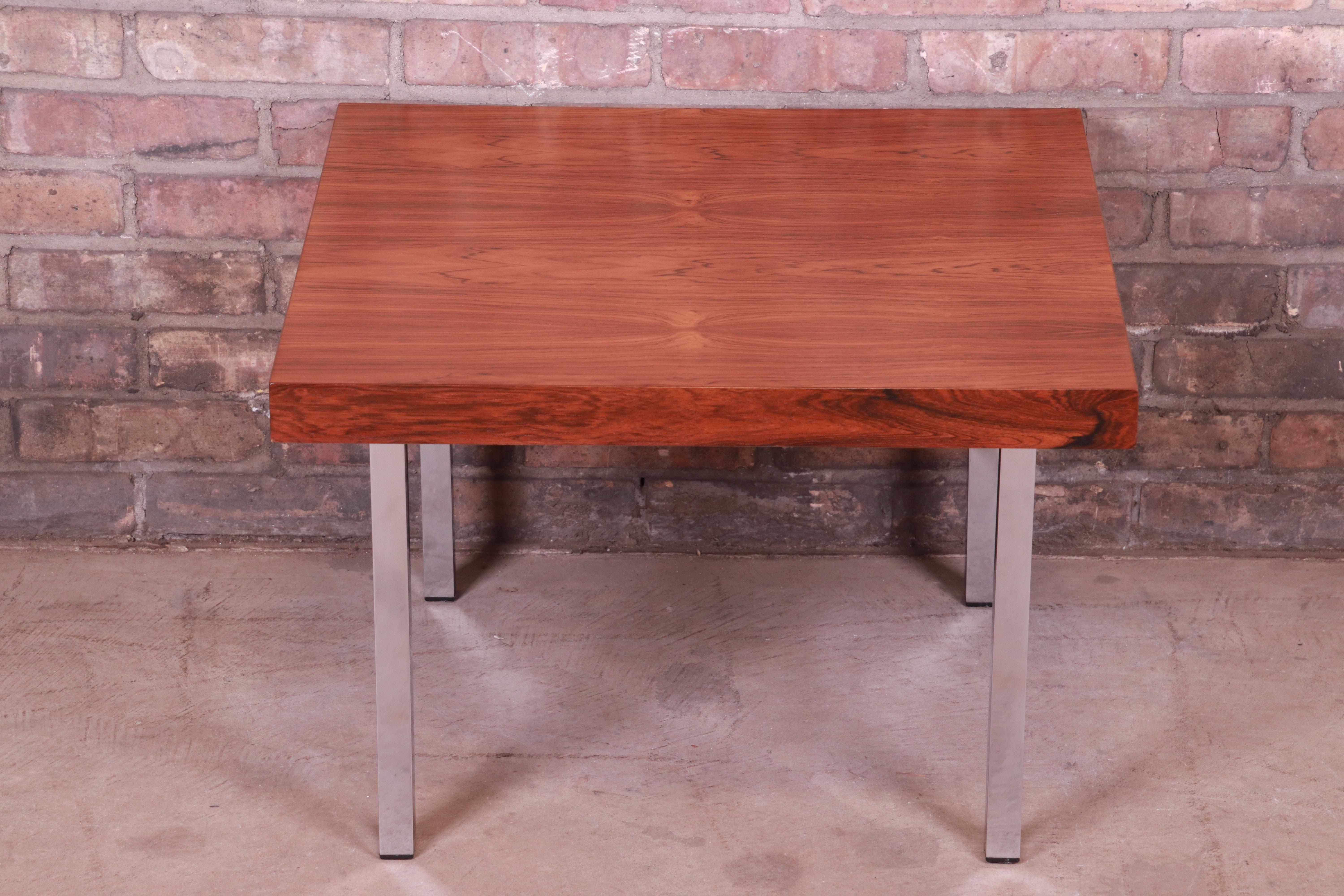 An exceptional Mid-Century Modern occasional side table

By Milo Baughman for Thayer Coggin

USA, 1966

Bookmatched rosewood top, with polished chrome legs.

Measures: 24