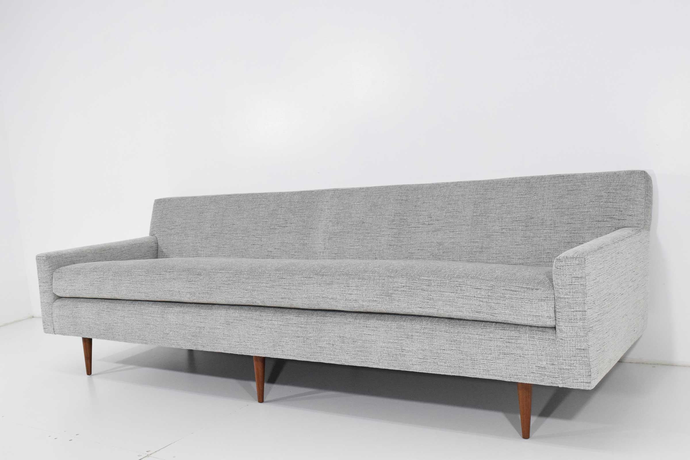 We have reupholstered this gorgeous midcentury sofa in a Mokum fabric from Holly Hunt. New foam added. Chenille fabric has tones of silver, grey, blues and whites and has a great feel. Very versatile and works in multiple environments.