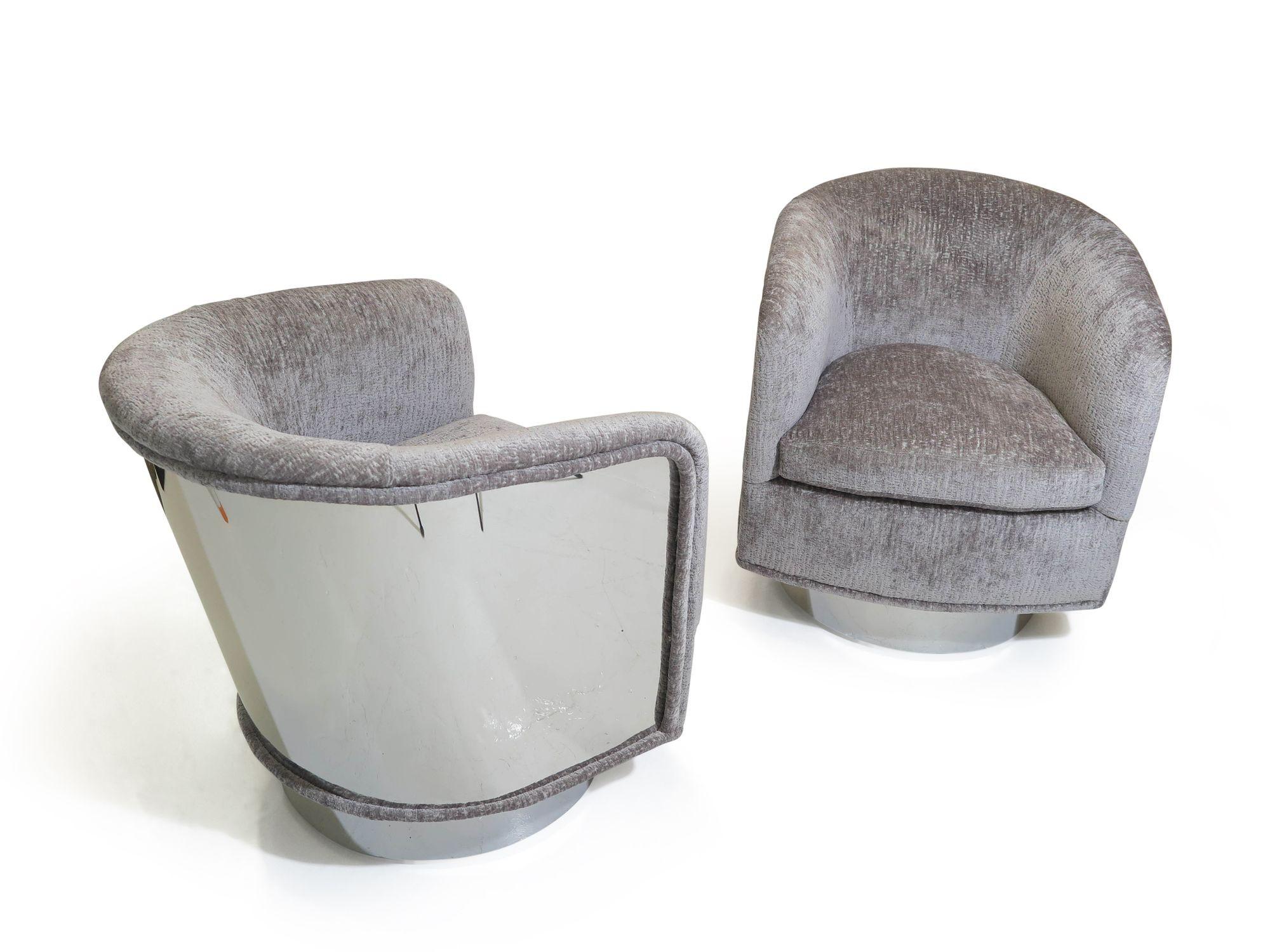 Pair of Swivel & Tilt lounge chairs designed by Milo Baughman for Thayer Coggin. Features a 360 degree swiveling mechanism with tilt. The chairs are very comfortable and flex as ones moves. Polished steel backs in a mirror finish and upholstered in