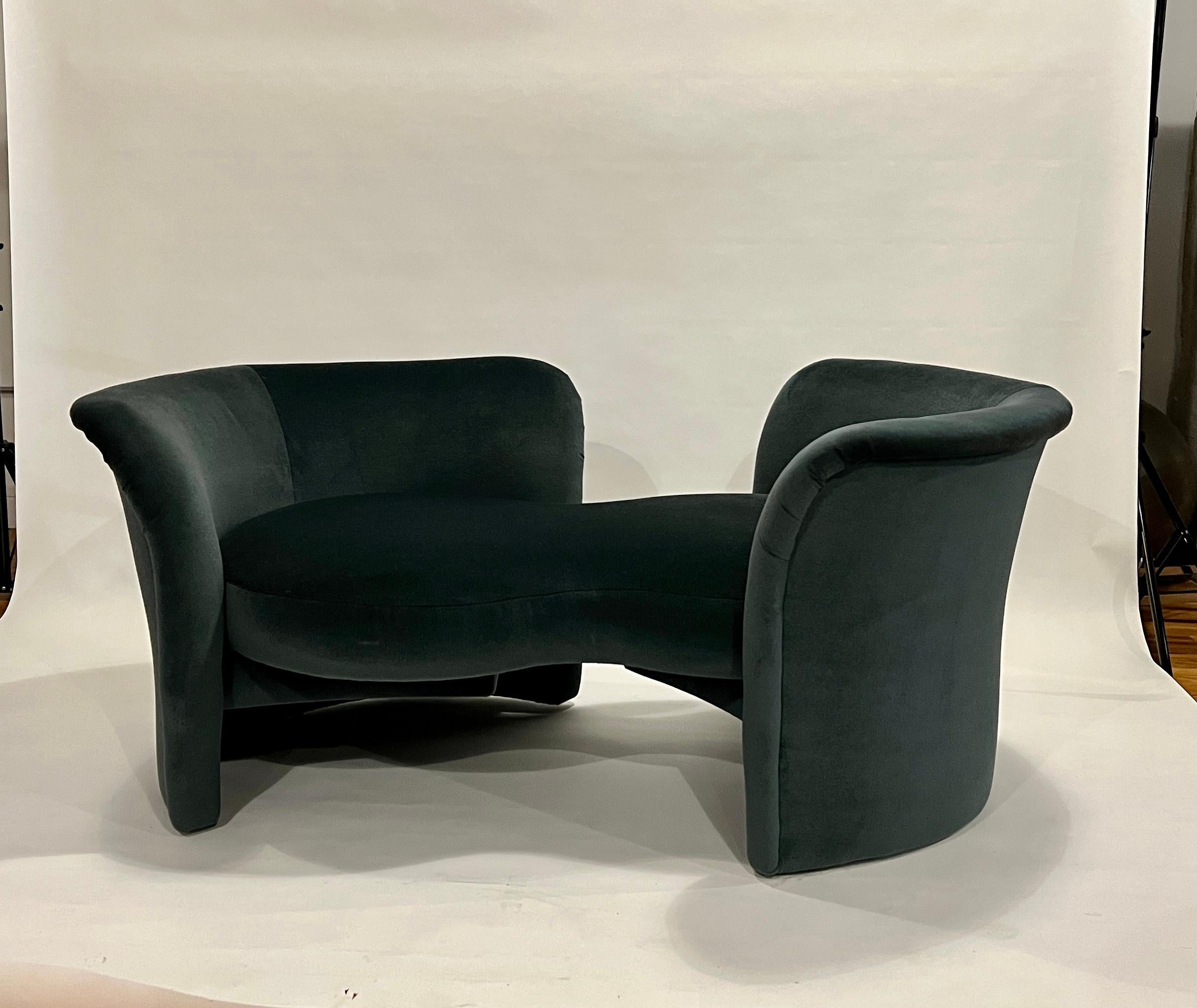 Milo Baughman loveseat with swivel arms to transform from a loveseat to a tete-a-tete. This 20th century Thayer Coggin classic sofa has been newly restored in a dark teal mohair with pale bluish-cream color mohair pillows.