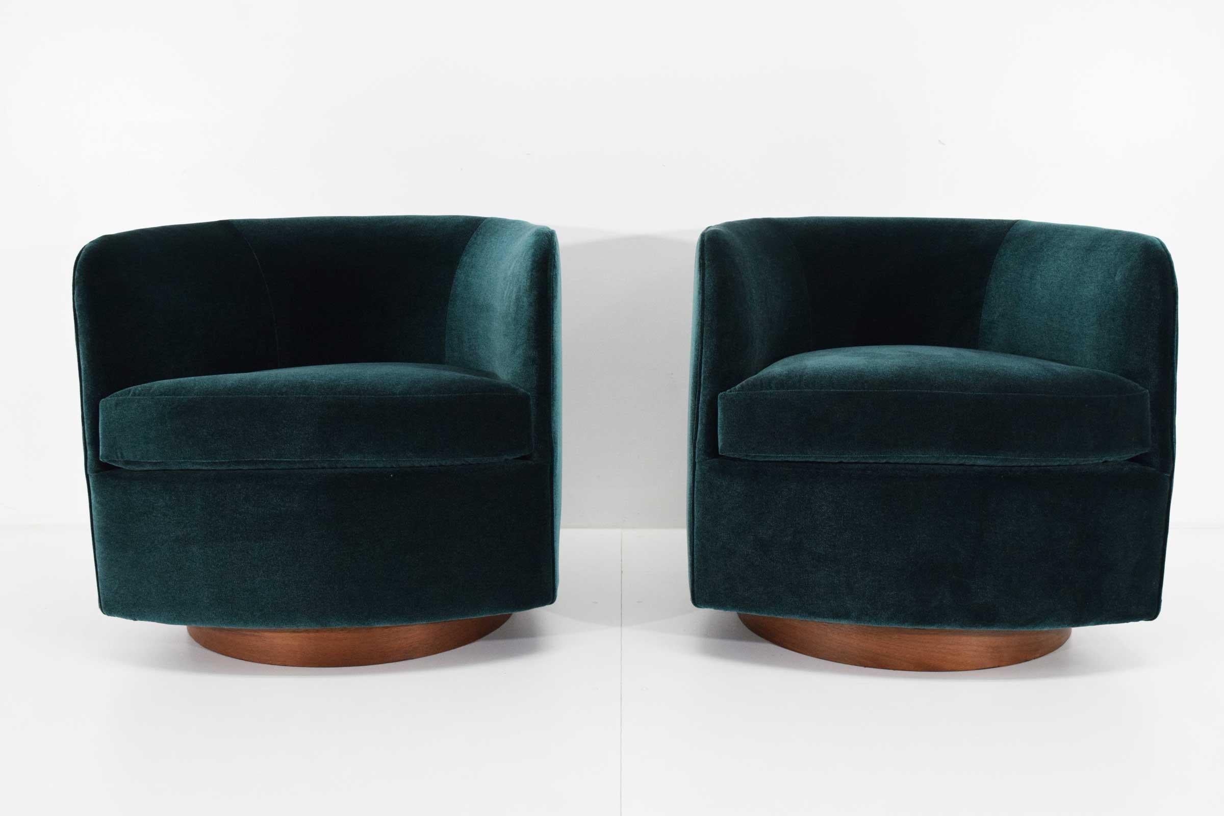 We love these chairs because of their style, comfort and the swivel. A Classic with walnut plinth base by Milo Baughman for Thayer Coggin. We have reupholstered in a rich Holly Hunt fabric.