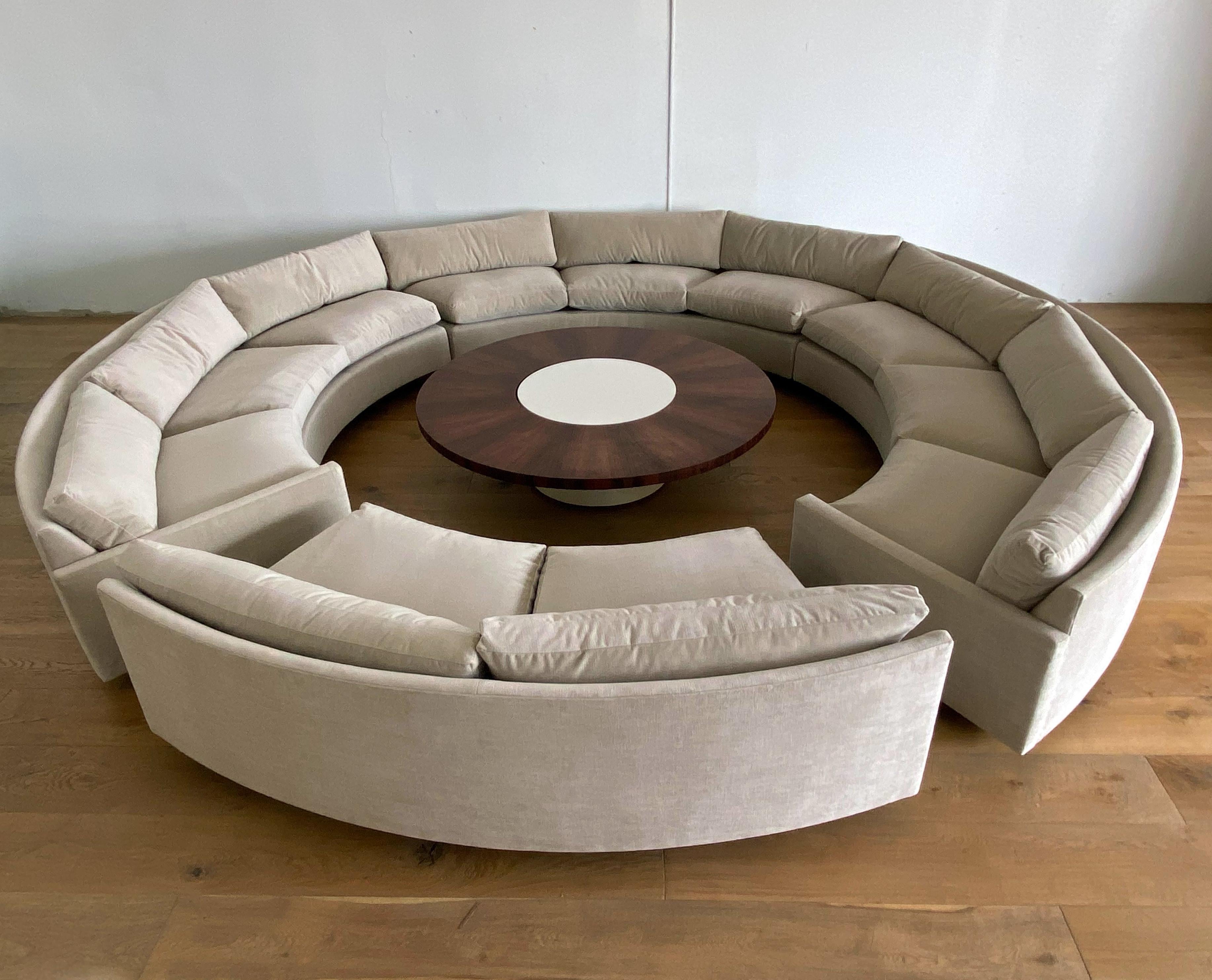 This circular sofa is the most complete Milo Baughman circular sofa I've ever seen. Upholstered in a neutral light tan velvet, this rosewood plinth sofa is not only beautiful, it's ridiculously comfortable, and has room for you and 15 of your