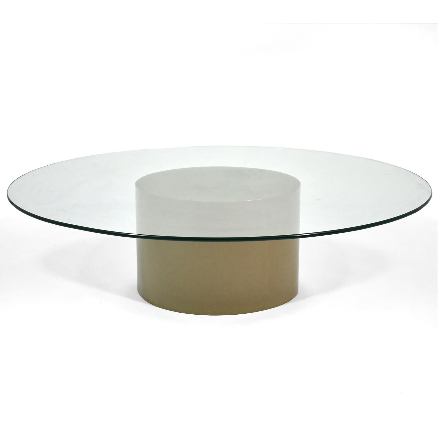 This Milo Baughman coffee table by Thayer Coggin features a cylindrical base of lacquered wood in a warm, putty colored gray with a large 54