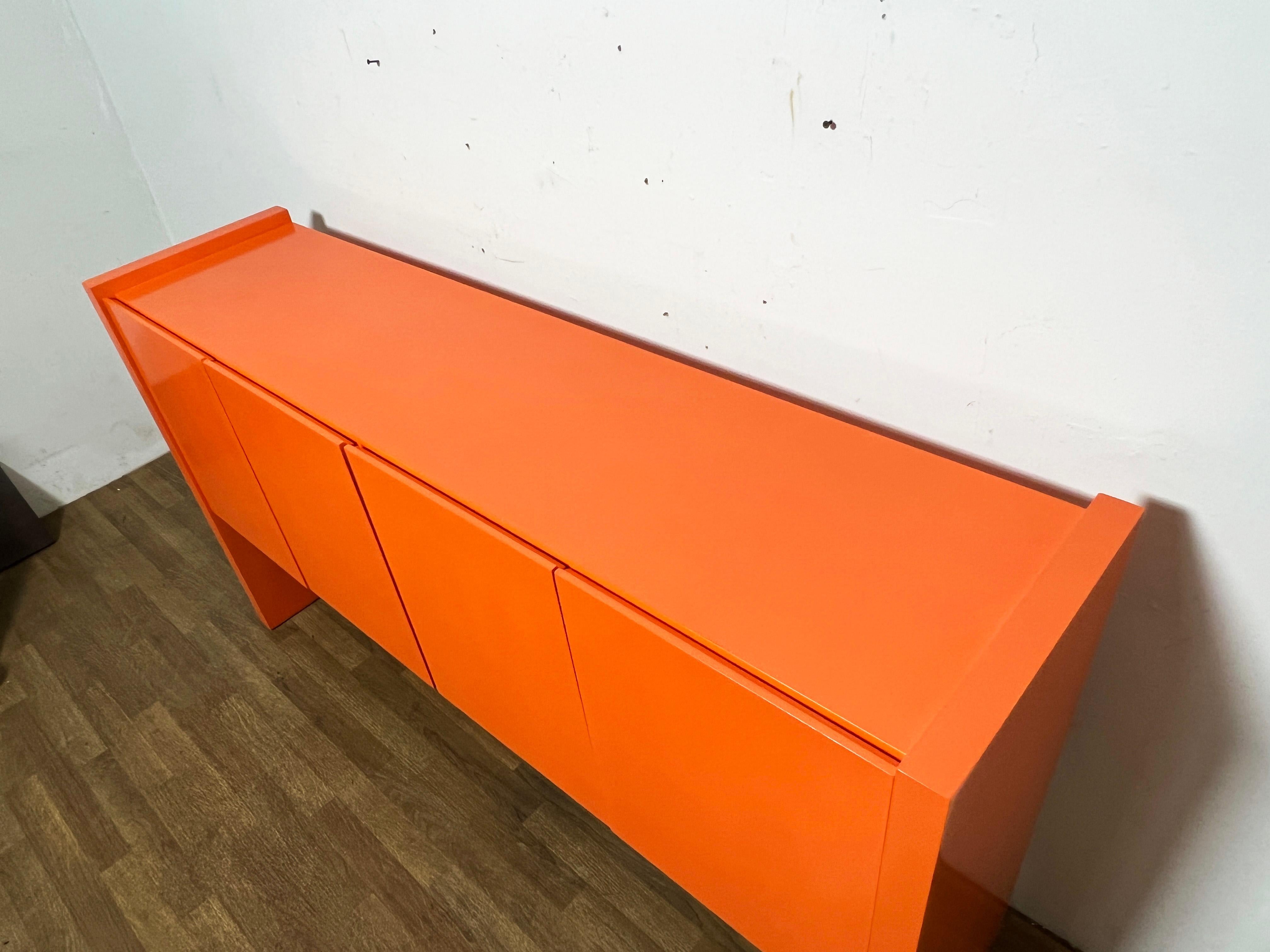 Four door  credenza by Milo Baughman for Thayer Coggin in an-orange high gloss lacqureed finish, circa 1970s.