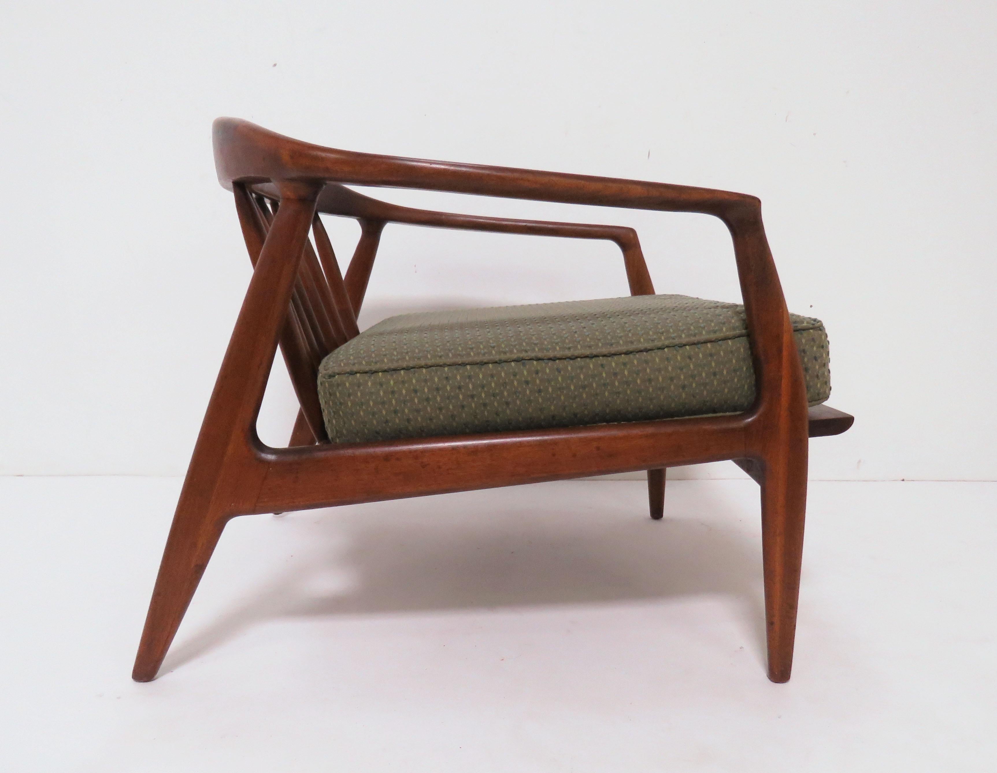 Lounge chair in solid walnut with a spindled barrel back designed by Milo Baughman for Thayer Coggin, circa 1950s.