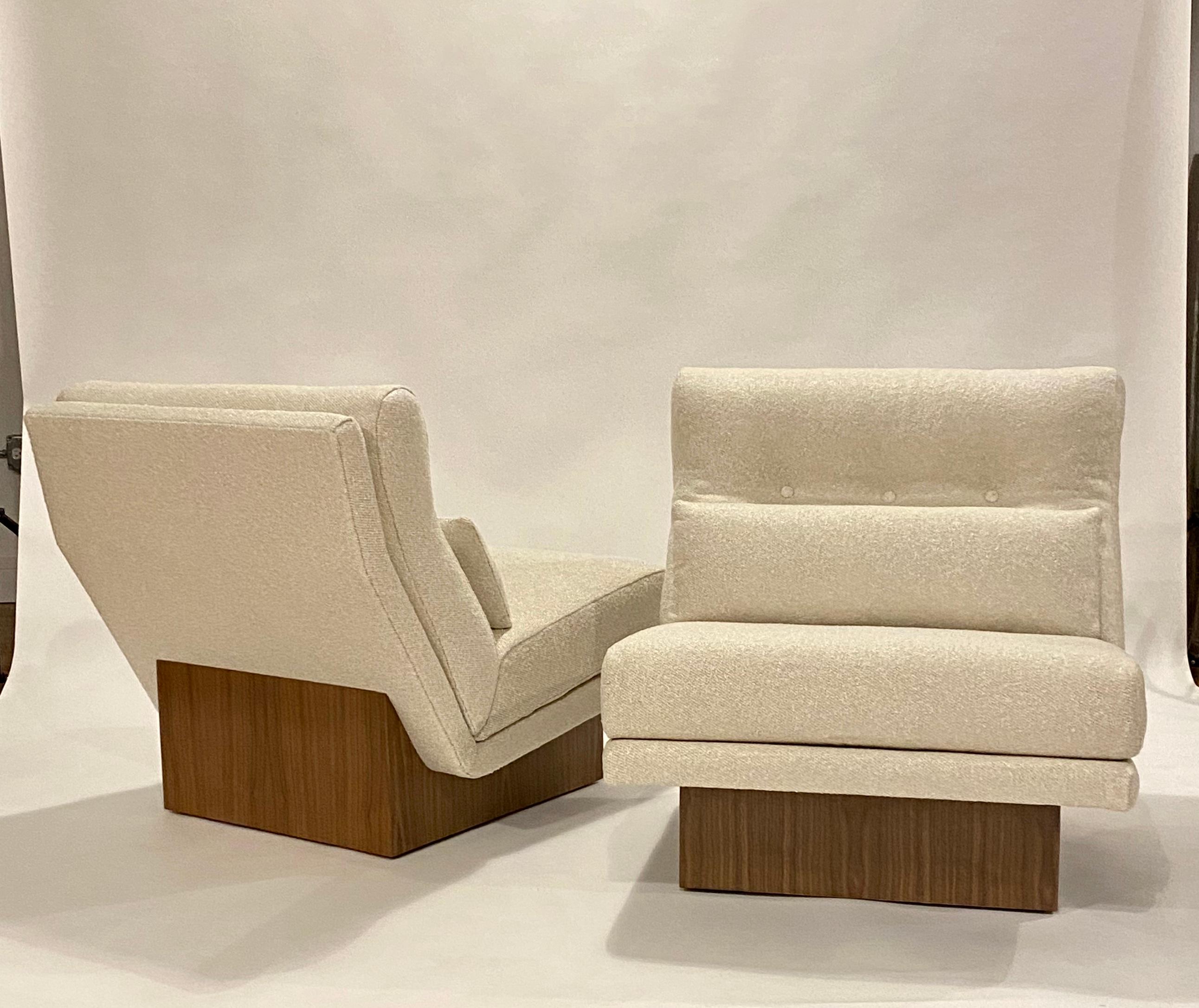 Midcentury wide slipper lounge chairs by Milo Baughman on newly restored walnut plinths and reupholstered in a pearl color boucle with lumber pillows.