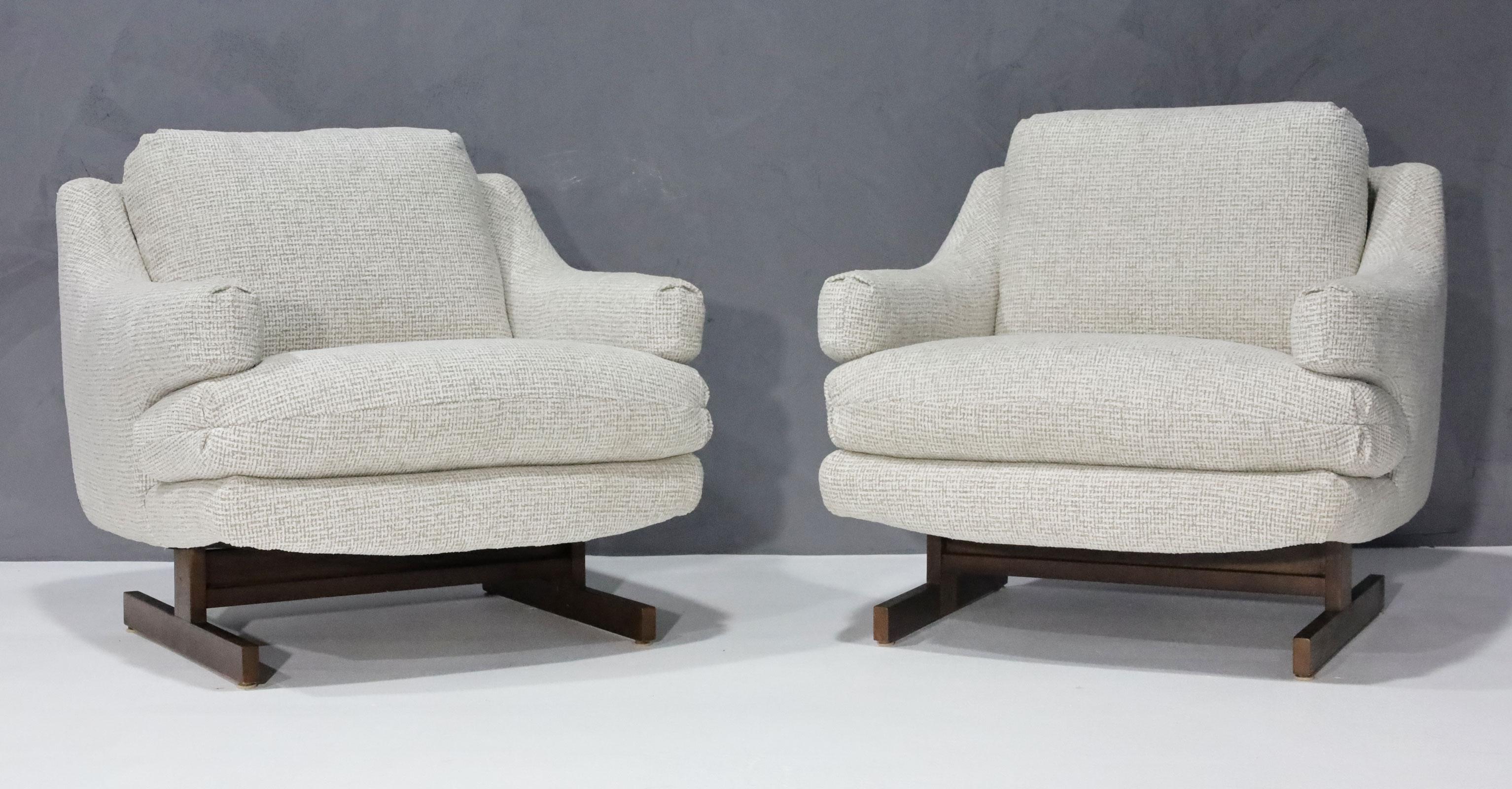 A fairly rare design in the style of Milo Baughman by O. B. Solie for Bernhardt/Flair. They have new upholstery in a chenille fabric of high quality. The bases are walnut and in a T-leg configuration. The chairs are very comfortable and have a great