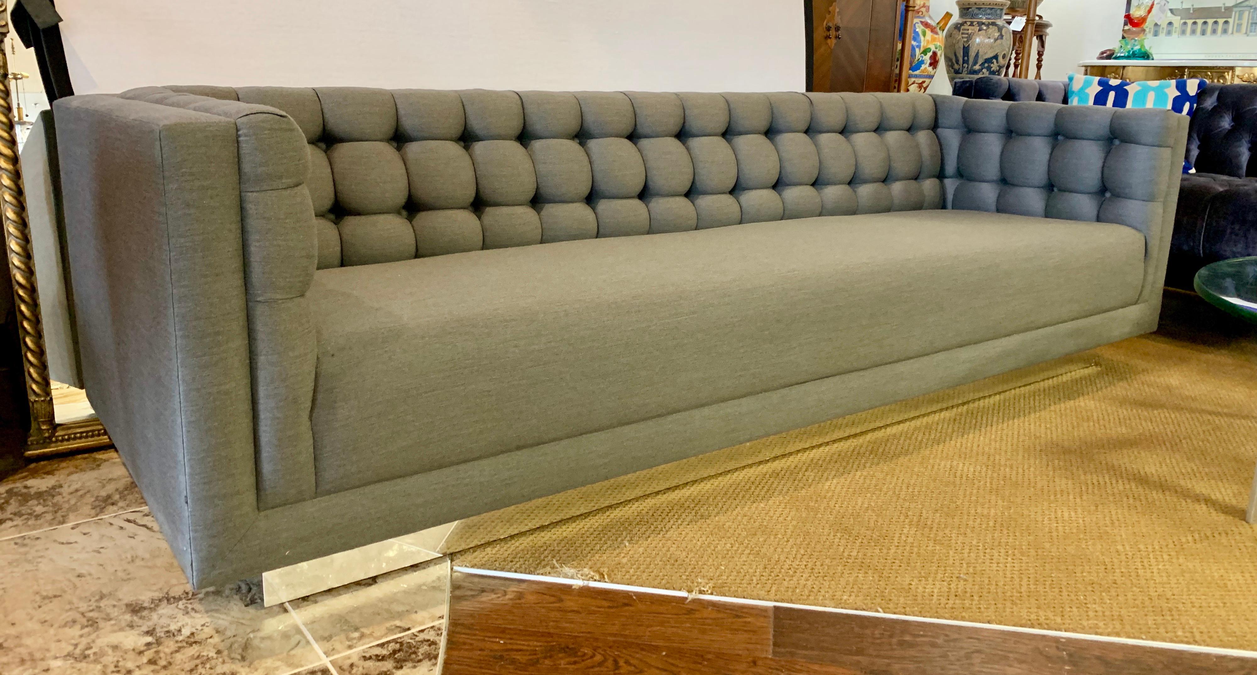 Stunning Milo Baughman Classic floating sofa. Custom with luxurious medium gray fabric.
The tufting looks like a work of art. The base floats and has chrome all around. An exceptional
piece with newer upholstery.