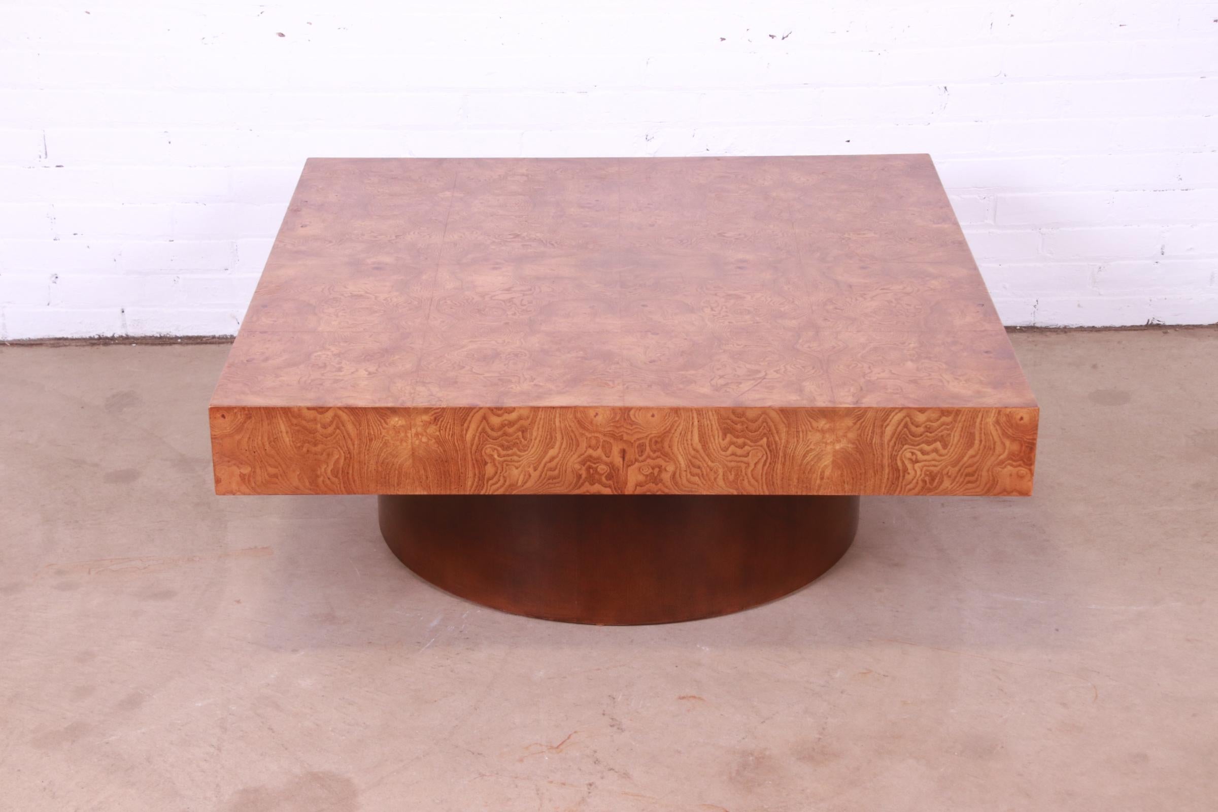 A gorgeous Mid-Century Modern coffee or cocktail table

Attributed to Milo Baughman for Thayer Coggin

USA, Circa 1970s

Stunning burl wood top, on walnut drum base.

Measures: 42
