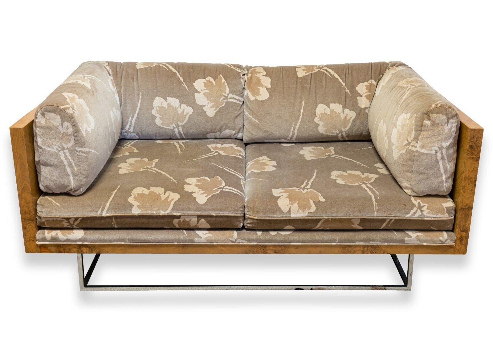 A Milo Baughman burlwood & chrome loveseat. This absolutely stunning loveseat is a mid century modern gem. This piece features some fantastic design from Milo Baughman. The details include the chrome base legs leading up to the burlwood sides and