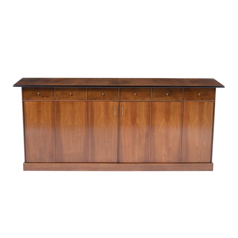 A sleek mid-century modern executive cabinet by Directional for their custom collection is crafted out of walnut wood covered in an exotic burl veneer and has been stained a rich walnut and ebonized color combination with a newly lacquered finish.