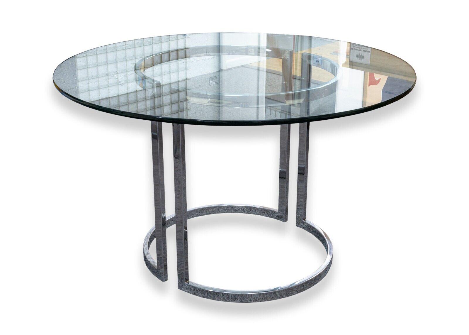 A Milo Baughman contemporary modern chrome dinette table and 4 chairs. A classic set from Milo Baughman featuring a round glass dinette table with a two piece chrome base, and 4 chrome dining chairs with a white upholstery. This whole set is in good