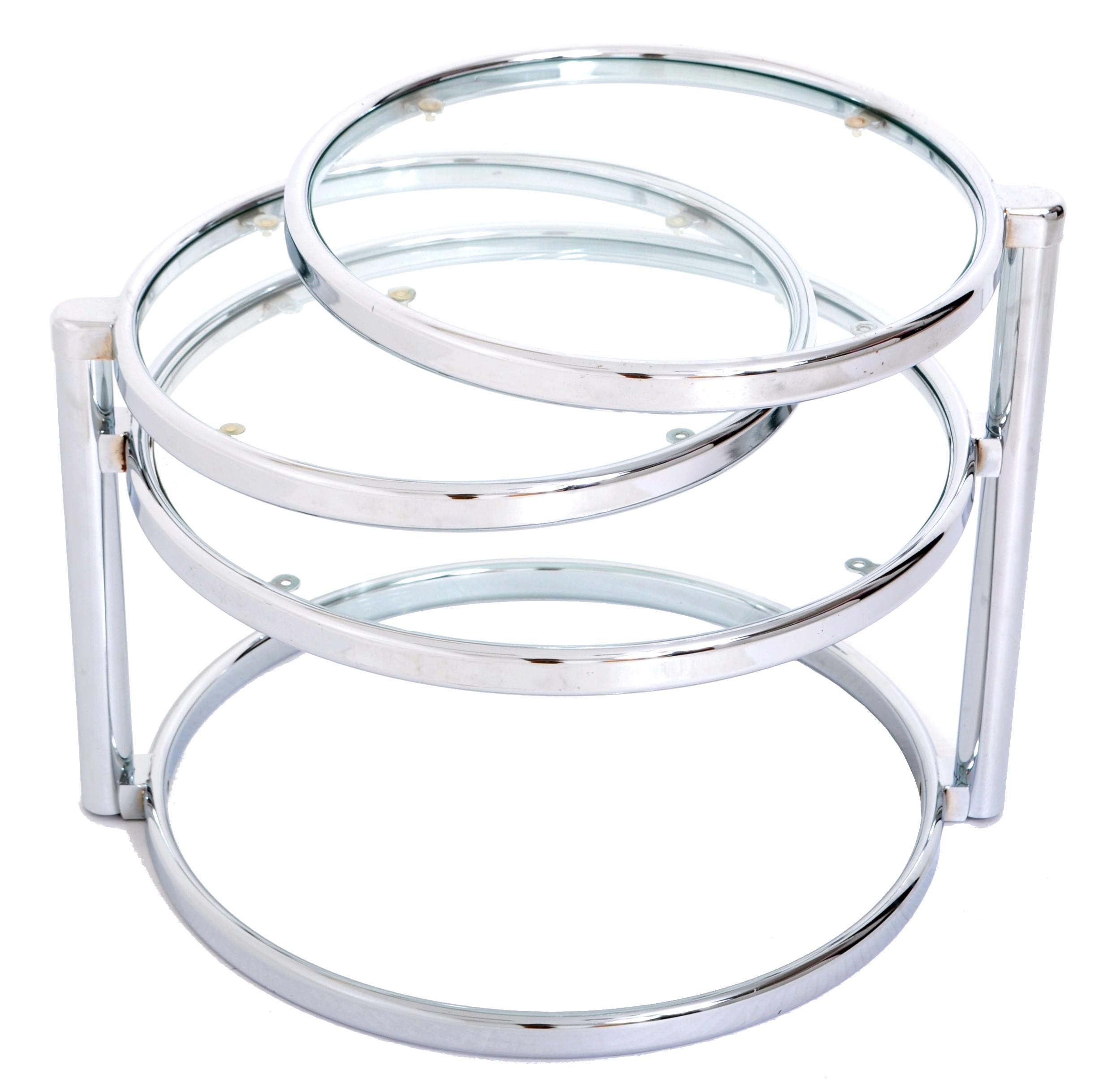 The nickel-plated brass table having three circular glass topped tables, two of which swivel into different positions. The table is all original and in good shape.

Measures: 23