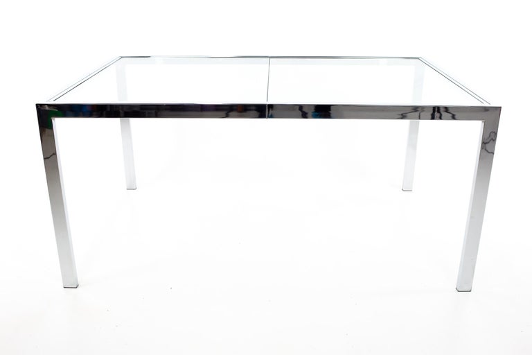 Mid Century chrome expanding dining table in the style of Milo Baughman.
Table measures: 60 wide x 38 deep x 27.75 inches high

This piece is available in what we call restored vintage condition. Upon purchase it is fixed so it’s free of watermarks,