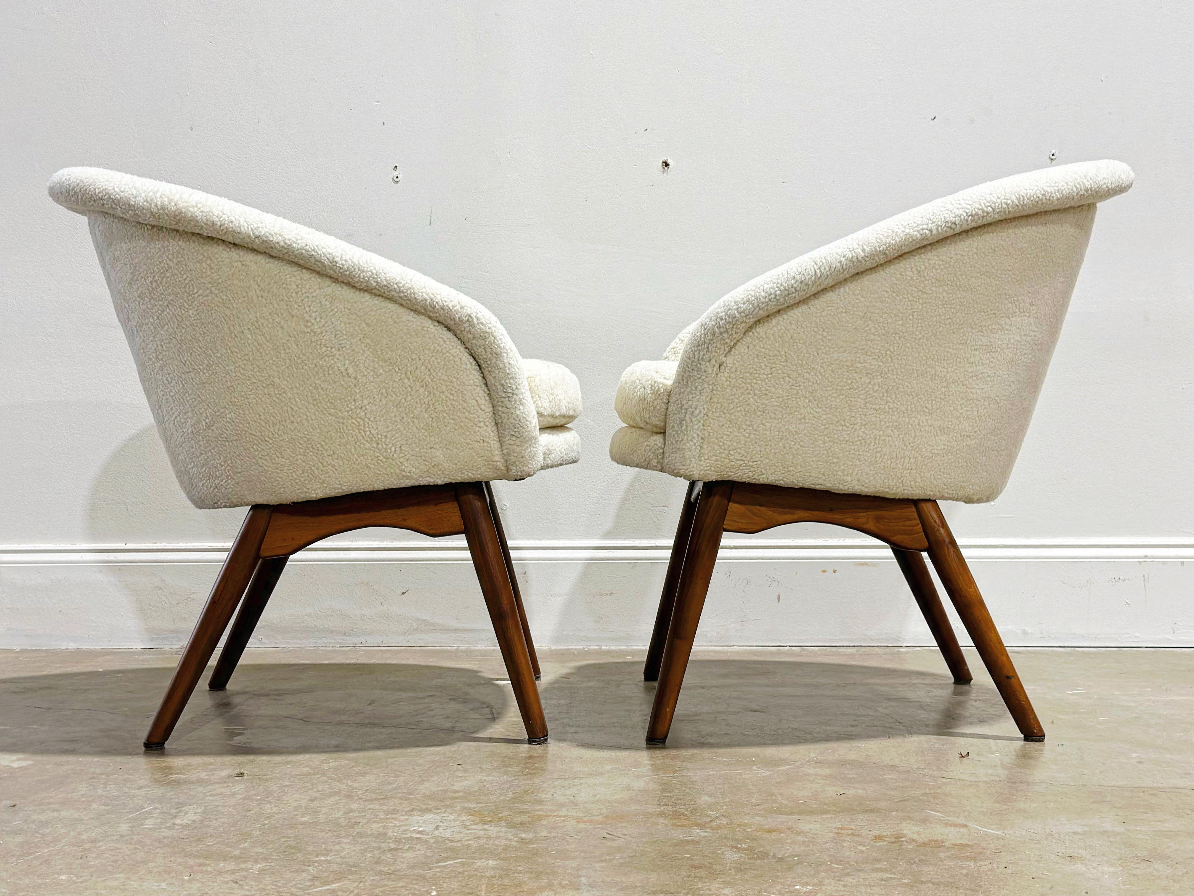 Pair of uncommon petite occasional barrel back chairs by Milo Baughman for Thayer Coggin, circa early 1960's. Gorgeous silouhette - sherpa boucle upholstered sculpted rounded back shells sit atop solid American black walnut bases with exposed