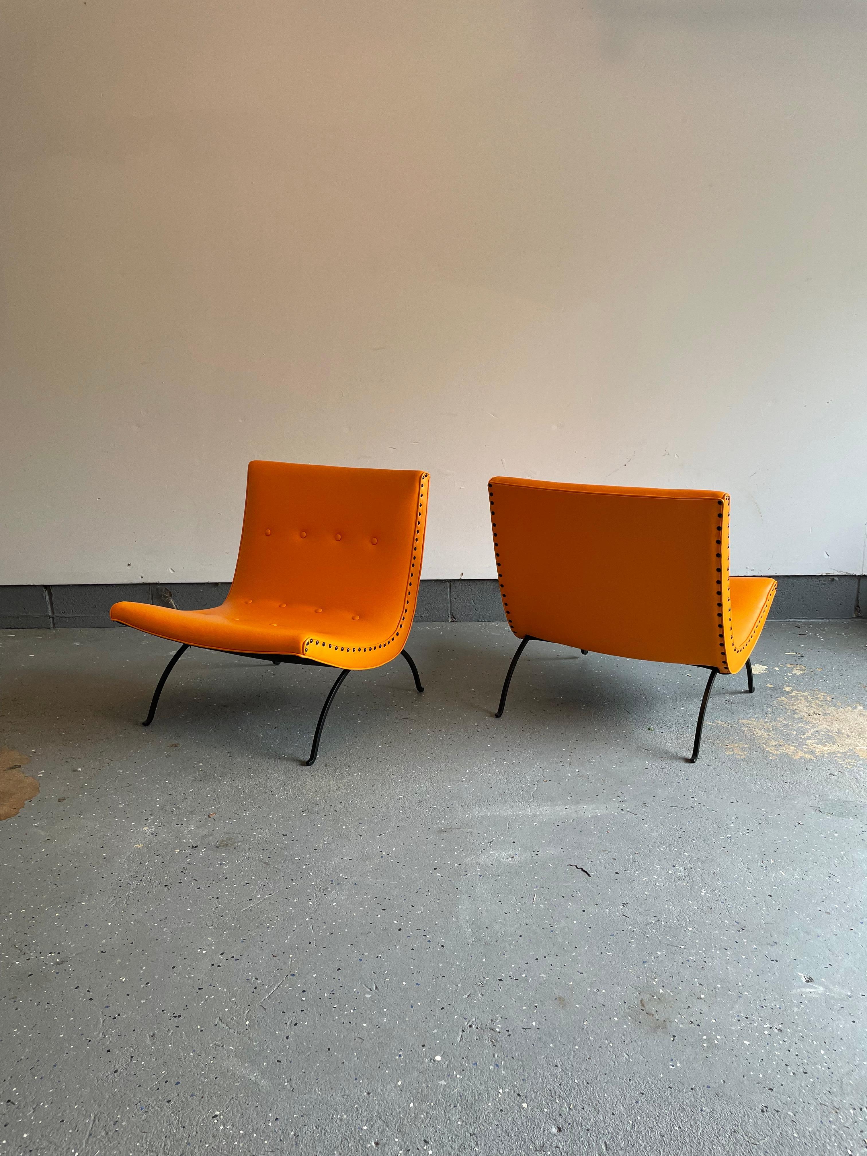 Rare pair of lounge chairs designed by Milo Baughman for James Mfg. Chairs were reupholstered about a year ago in an orange vinyl and saw light use since then. Chairs come with an original tag that was affixed to the underside of one of the chairs.