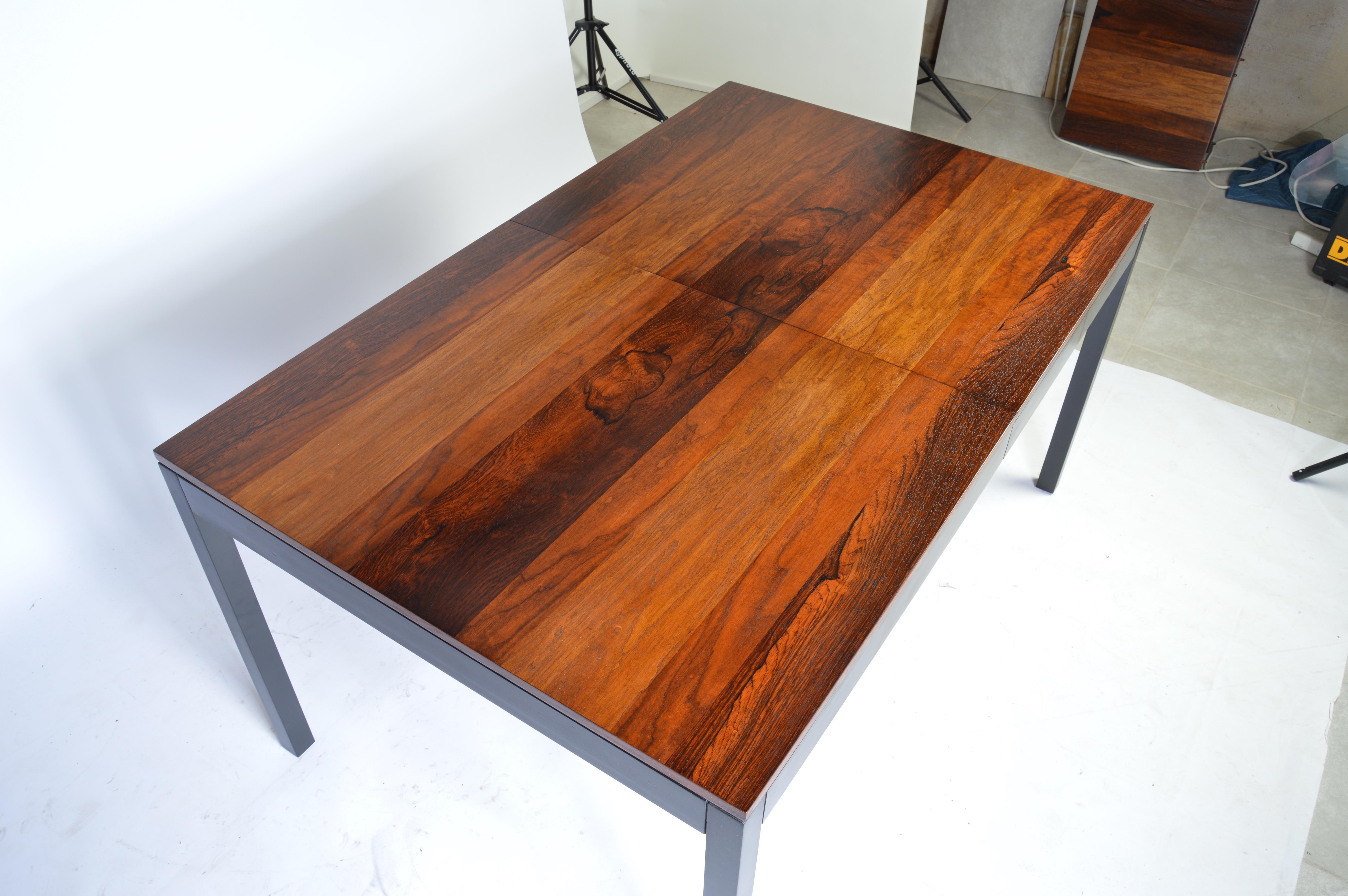 An expandable dining table designed by Milo Baughman for Directional having a blend of rosewood, walnut and ash woods. The top consists of solid planks. The legs and frame are solid wood as well. 
 Length without leaves inserted is 72