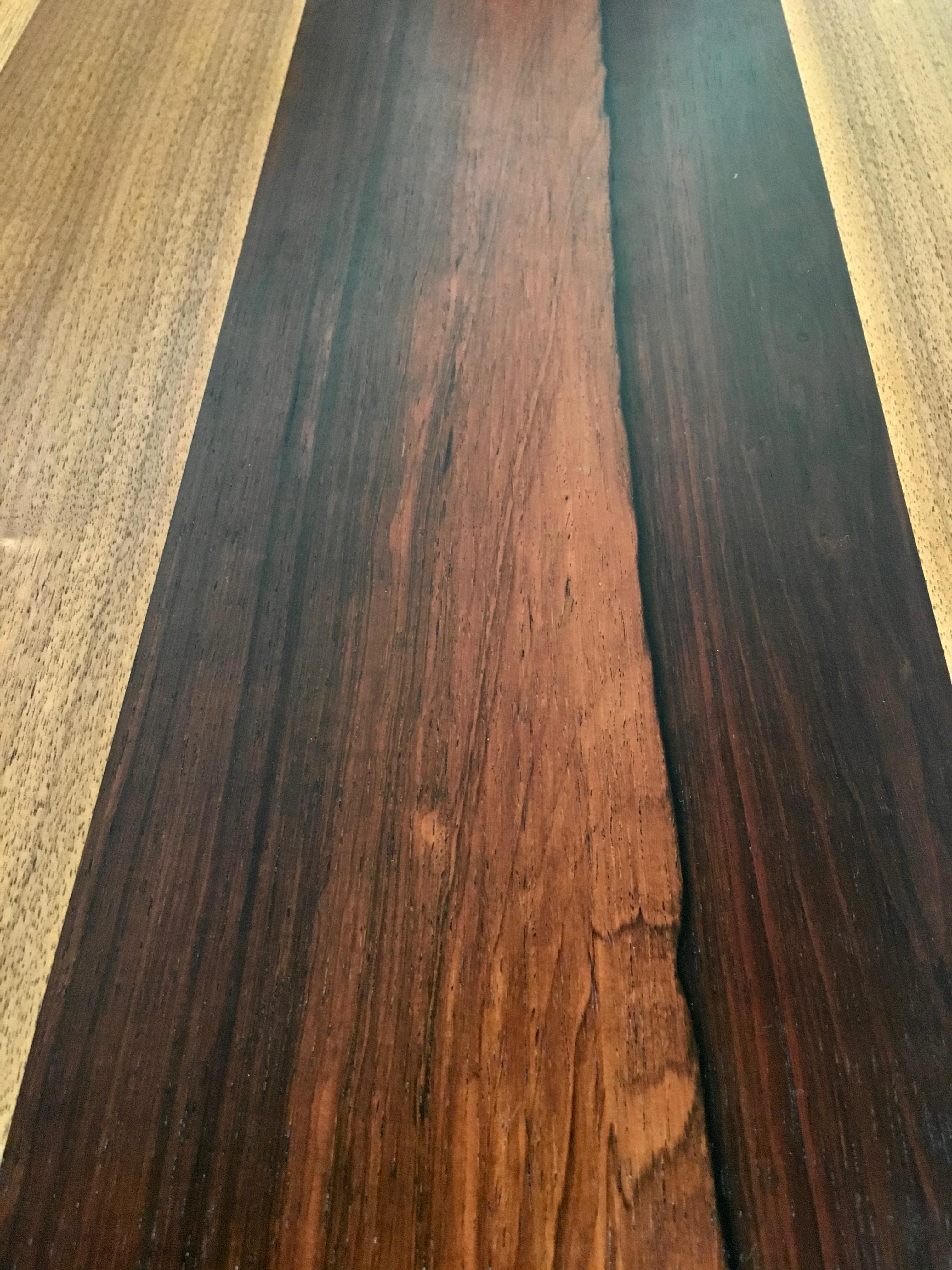 Mix of rosewood, walnut and ash makes this table top stand out supported by four ebonized legs
and two 20