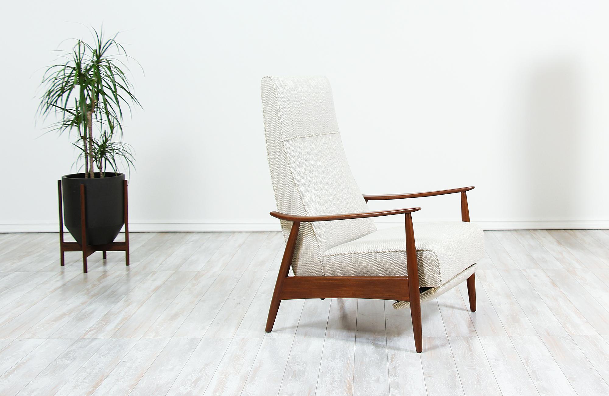Elegant reclining chair Model-74 designed by Milo Baughman for Thayer Coggin in the United States circa 1950s. This comfortable midcentury recliner features a newly upholstered seat rest in a soft wool blend tweed fabric supported by a warm walnut