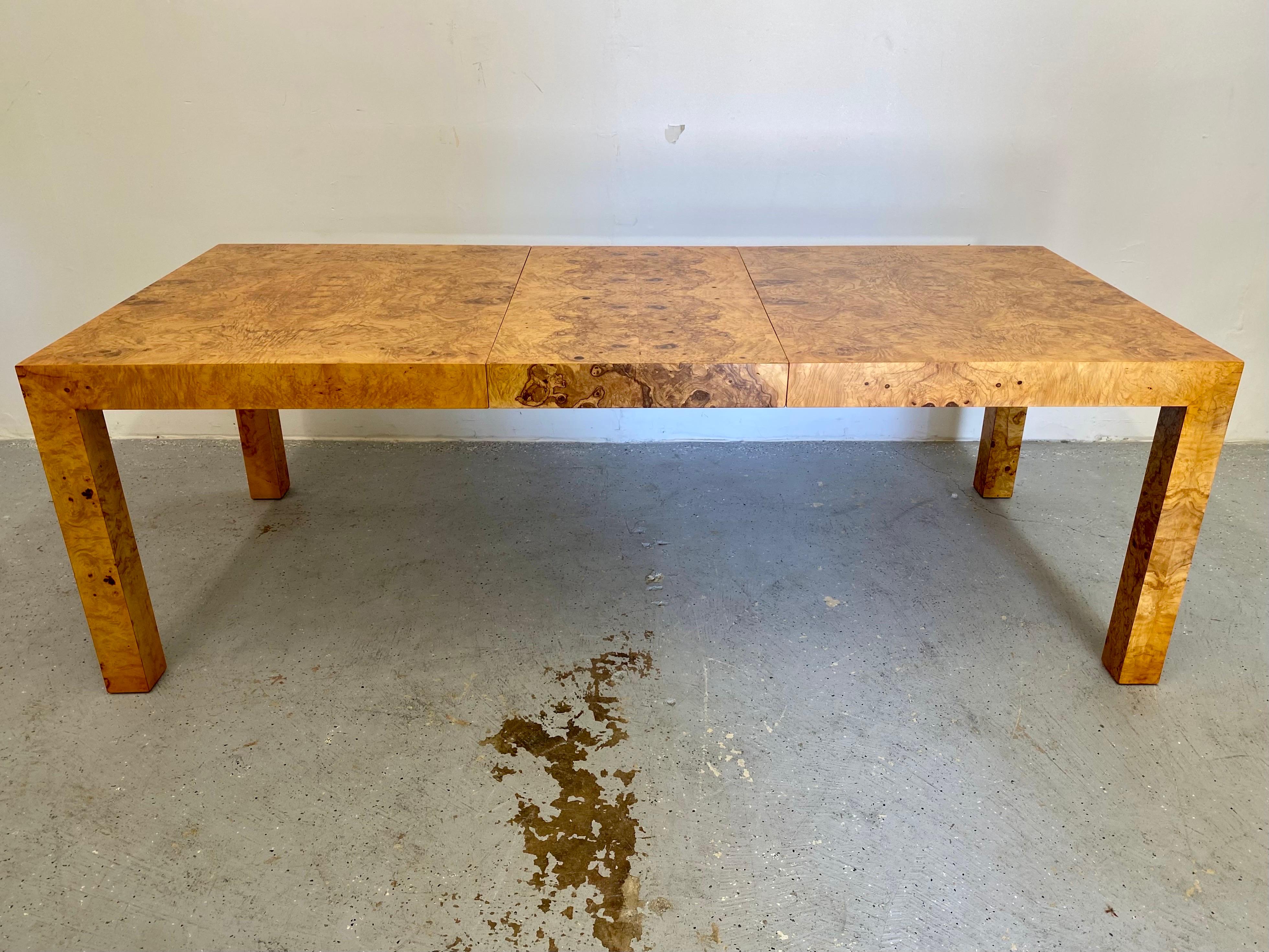 Classic dining table from Thayer Coggin with stunning olive burl grain. Dating to the 1970s and designed by Milo Baughman this pice has been restored and is in excellent condition. Measures 66