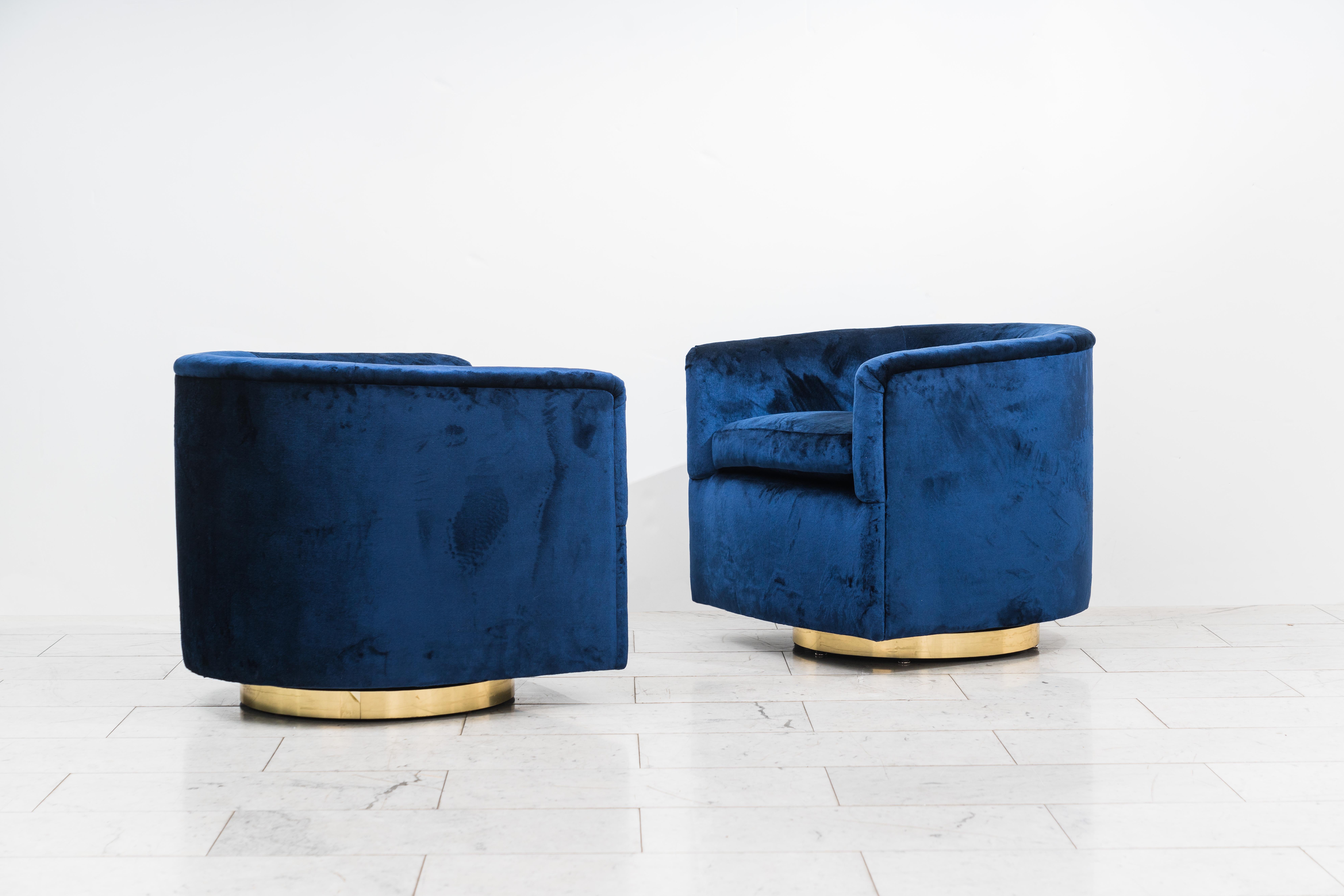A beautiful pair of swivel chairs designed by Milo Baughman. Each chair has a circular brass base that swivels with ease. Elegant in design, the chairs are also extremely comfortable, offering wonderful back support. Excellent condition.