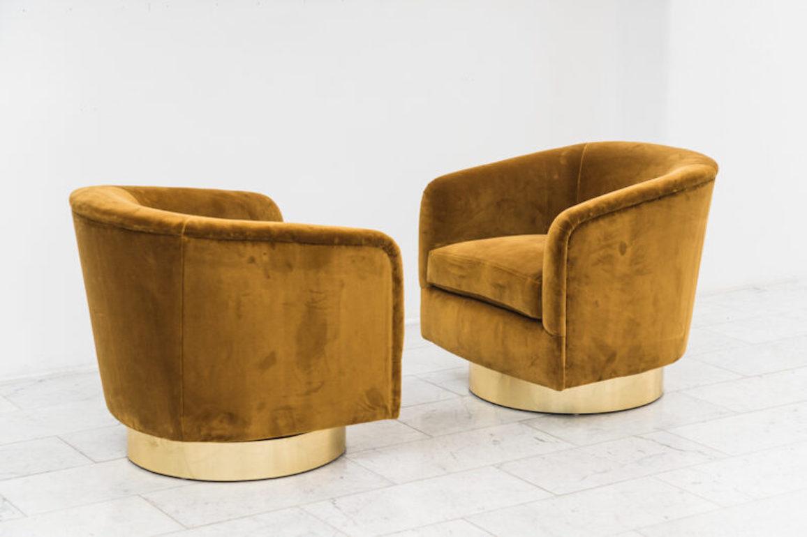 A beautiful pair of swivel chairs designed by Milo Baughman. Each chair has a circular brass base that swivels with ease. Elegant in design, the chairs are also extremely comfortable, offering wonderful back support. Excellent condition.