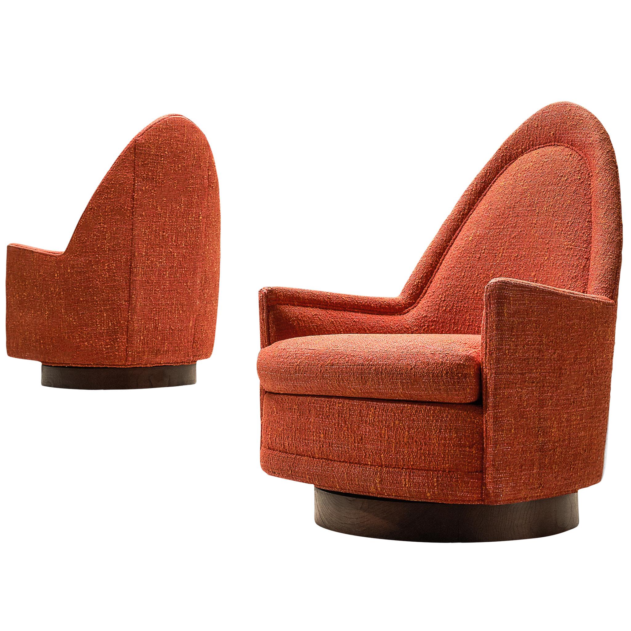 Selig, set of two swivel cathedral chairs, red fabric and wood, United States, 1960s. 

These lounge chairs which embrace the shape of the body, are very comfortable and easy to use, are a set which can be placed in the middle of a living space or