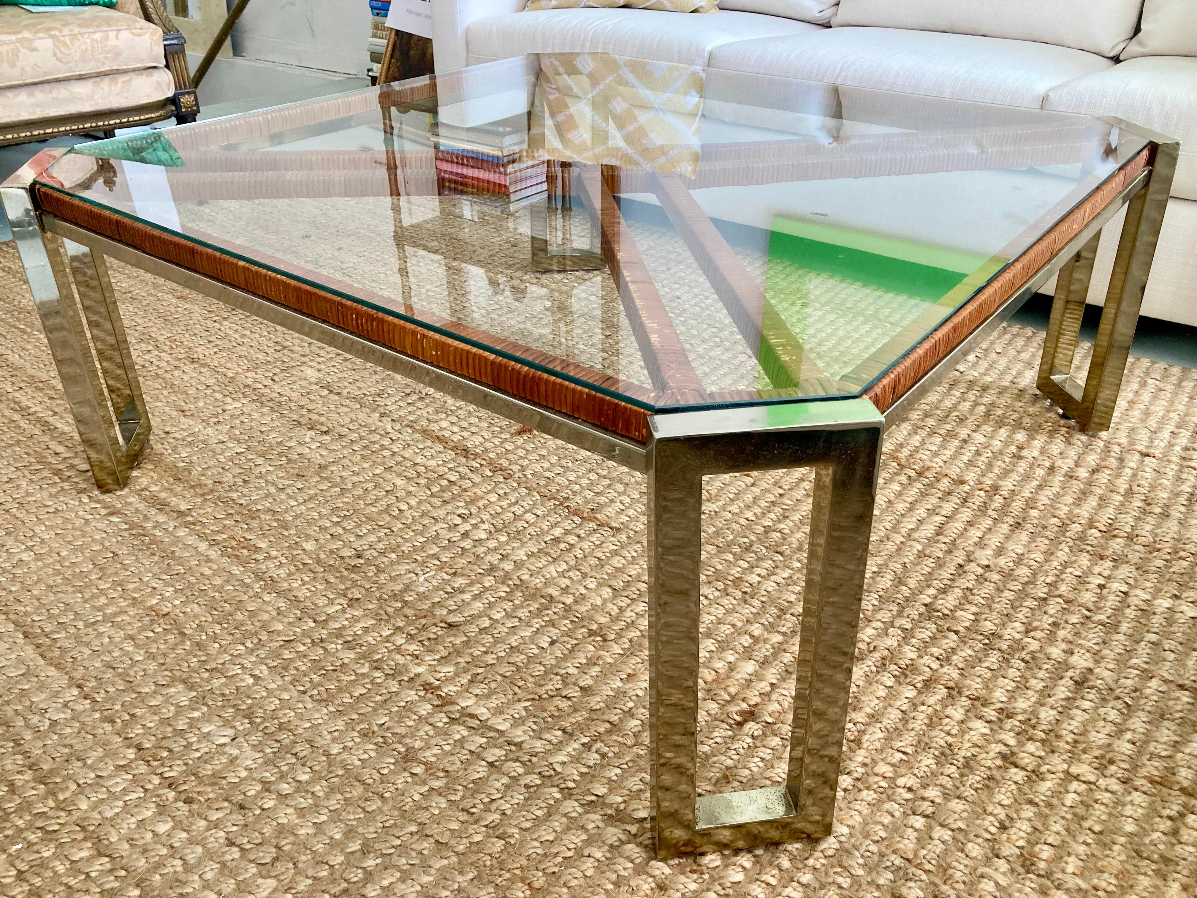 Milo Baughman wrapped rattan and warm chrome coffee table with glass inset top. Wonderful combination of materials and glass top allows you to see this combination. It is a square shape, but with clipped angled corners to add some additional