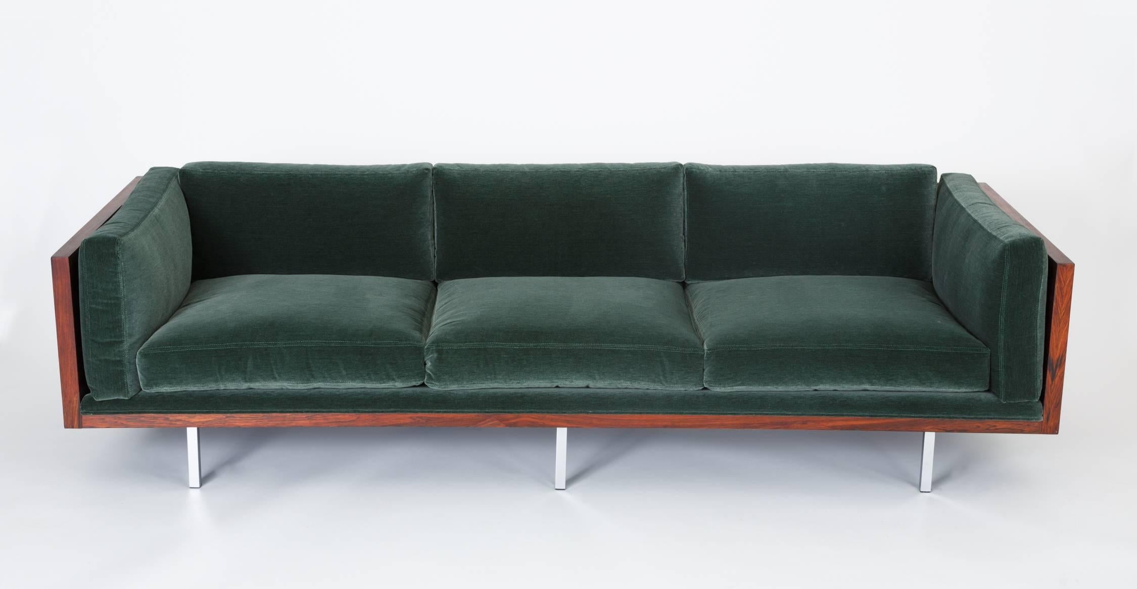 A sumptuous restoration of Milo Baughman's Classic 2165 sofa for Thayer Coggin. Designed in 1968, the sofa has a three-sided case in highly figured Brazilian rosewood, and the long, horizontal design appears to float above the ground on six