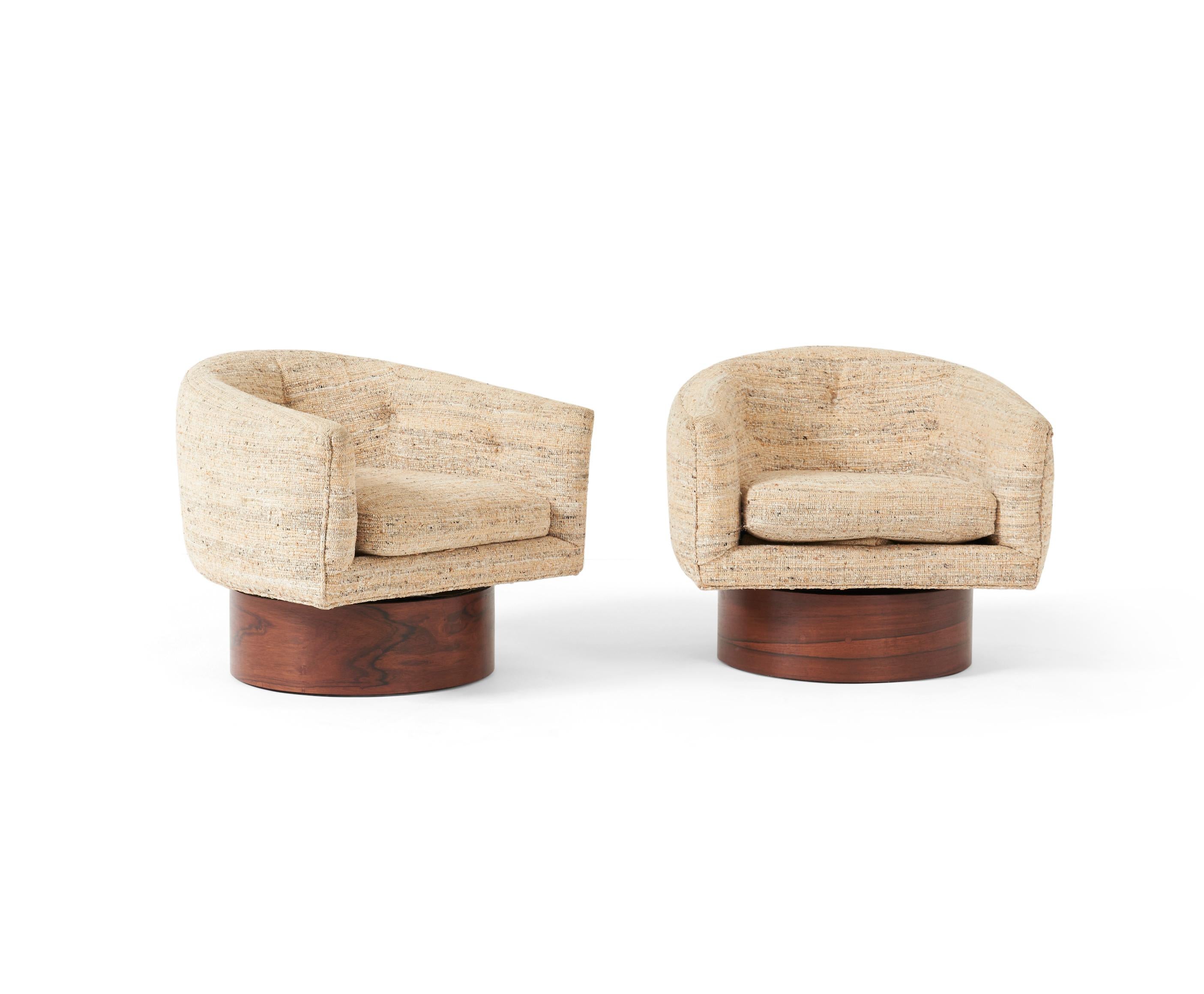 Rosewood swivel chairs by Milo Baughman. Rosewood bases have been meticulosly refinished. Original fabric. Circa 1960's