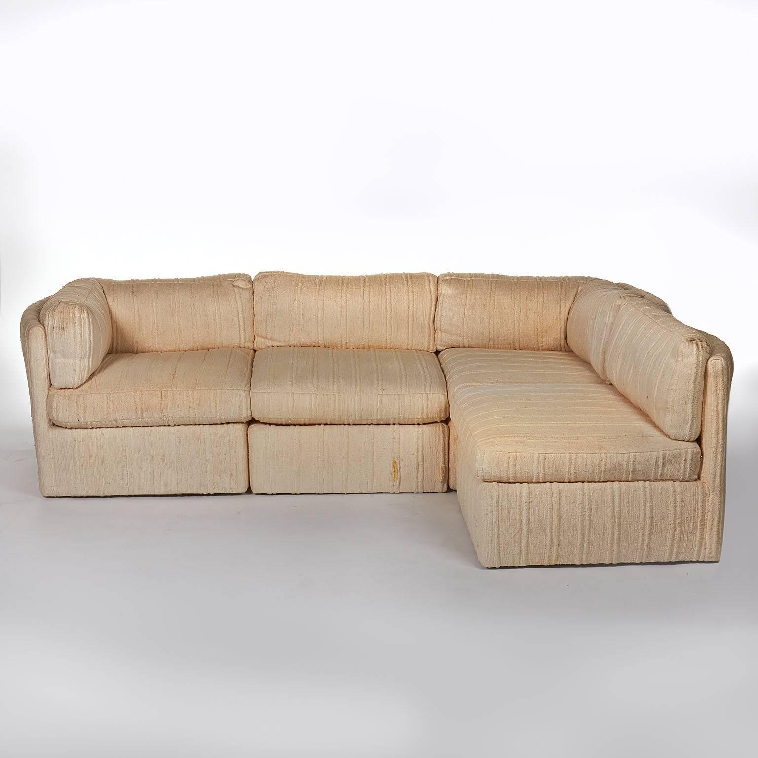 Large 1970s sectional sofa consists of three corner sections and three interior sections. Each section has a curved back and, as a result, the sofa reads like individual chairs placed together a striking and unusual design. Structurally sound;