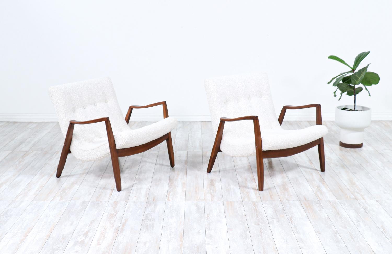 Pair of stylish ‘Scoop’ Lounge chair designed by Milo Baughman in the United States for James Inc. circa 1950s. These rare lounge chairs features an angled sculpted walnut wood frame with wide wood stretchers that hold the ‘scooped’ seat that