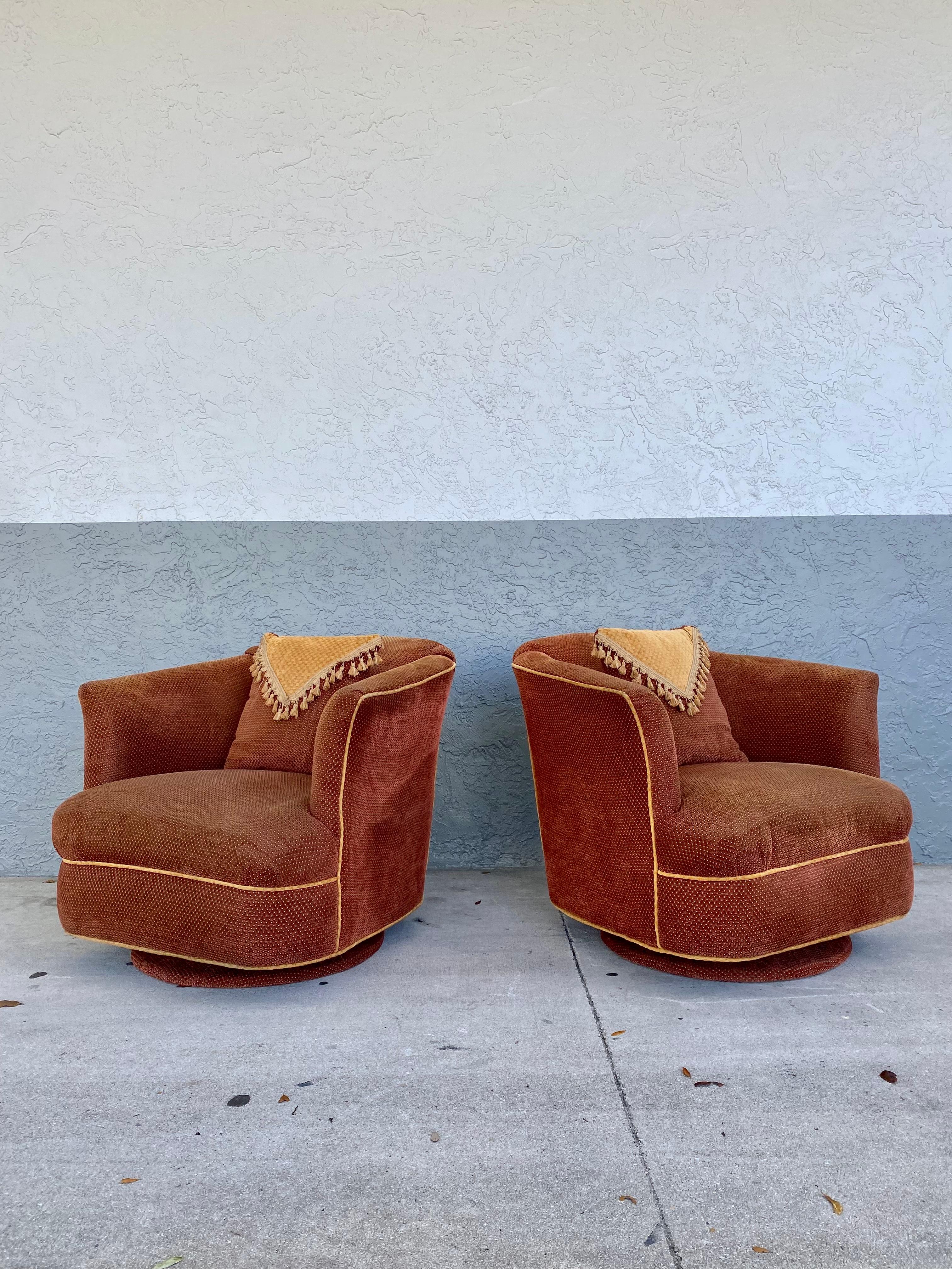 These rare and stylish upholstered swivel chairs are packed with personality! Outstanding design is exhibited throughout. Their beautiful and sculptural shape are attributed to Milo Baughman. The swivel and rocking barrel back chairs are upholstered