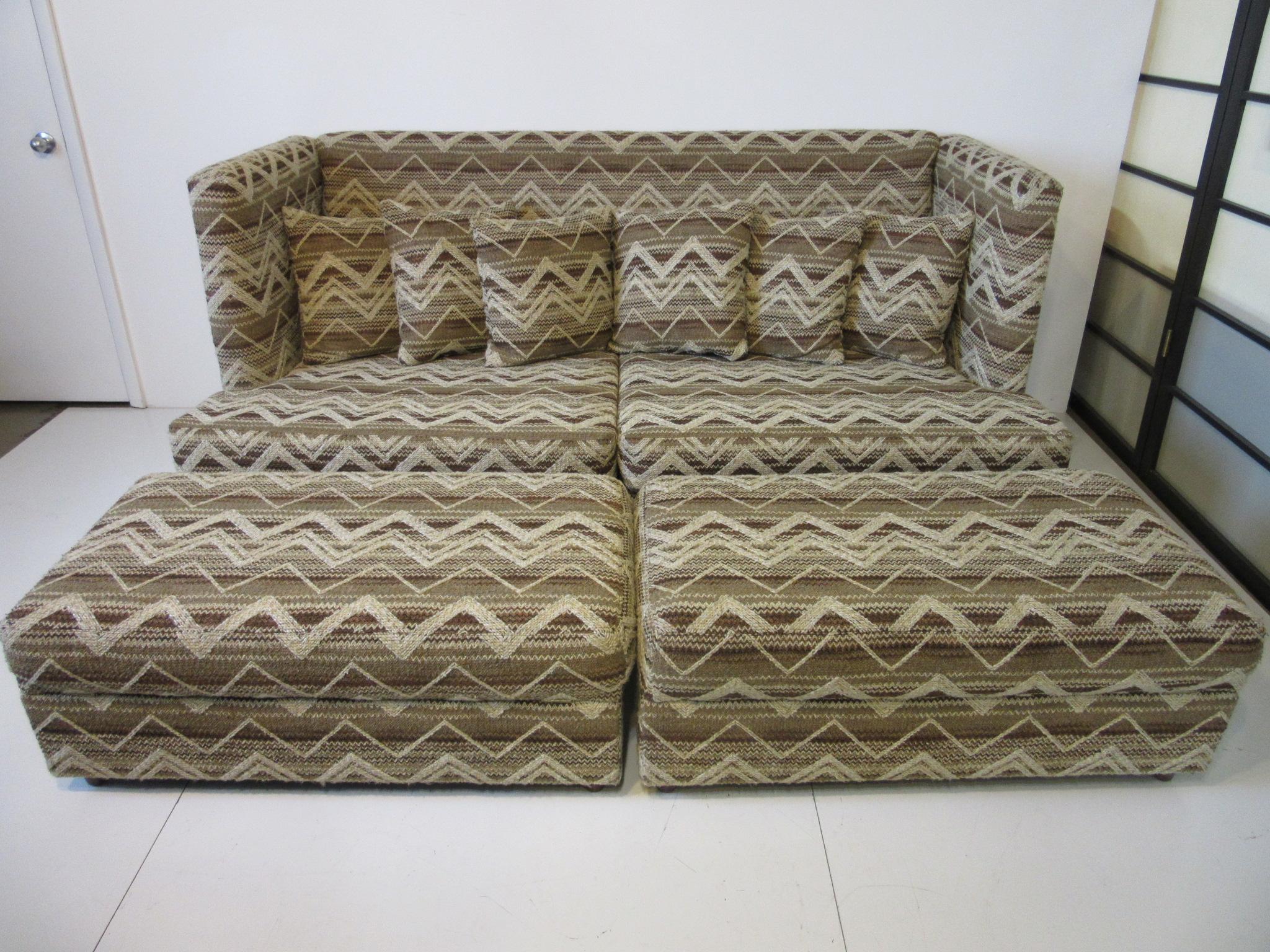 A hard to find Baughman shelter sofa with two matching storage ottomans, this sofa draws it's name for it cozy intimate sheltering feel with wall designed back and arms, six small throw pillows and large bottom cushion for quiet relaxation or