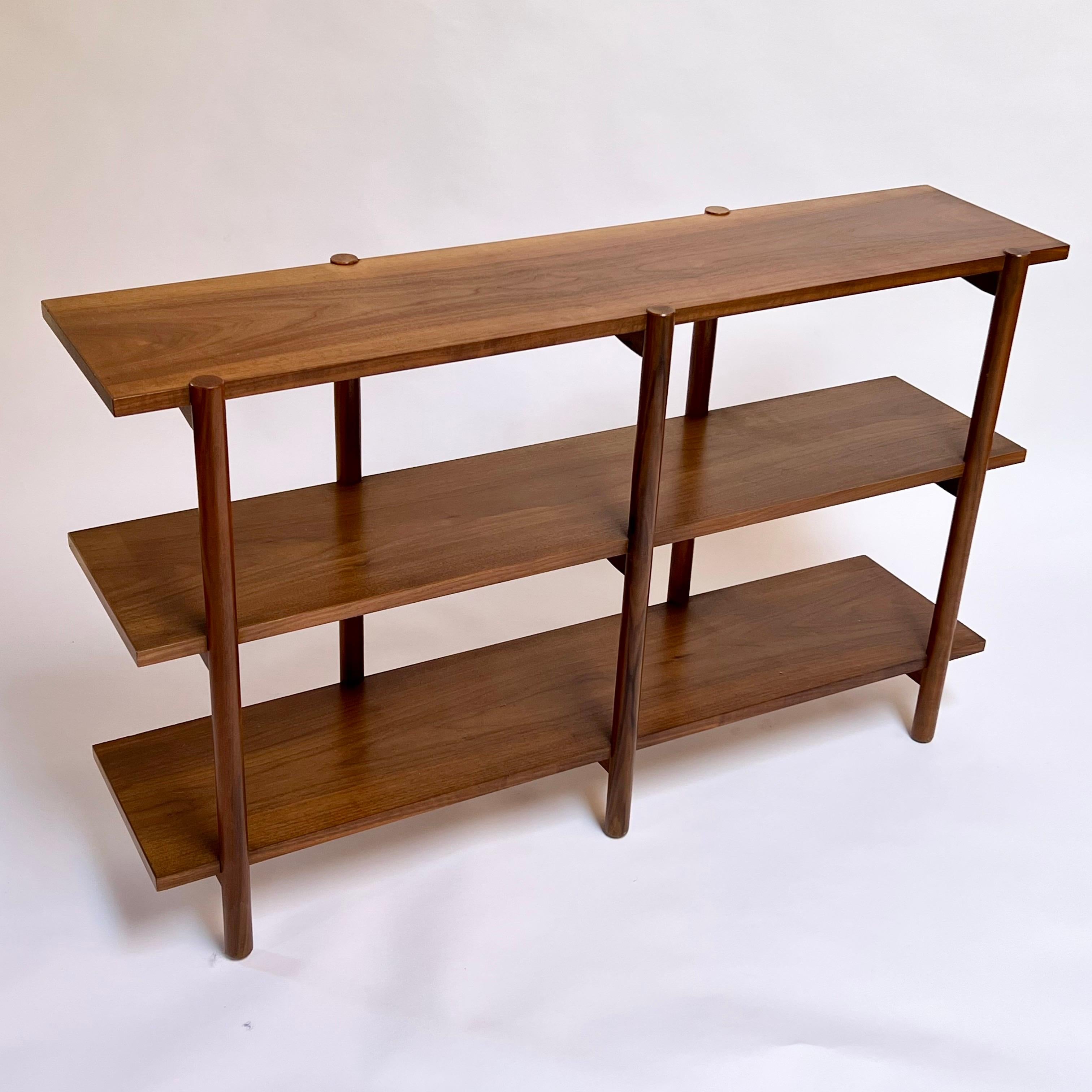 Stunning and very practicable three level shelving unit designed by Milo Baughman for Glenn of California. Well documented and uncommon piece executed in walnut. Beautiful vintage condition. Shows beautifully. 