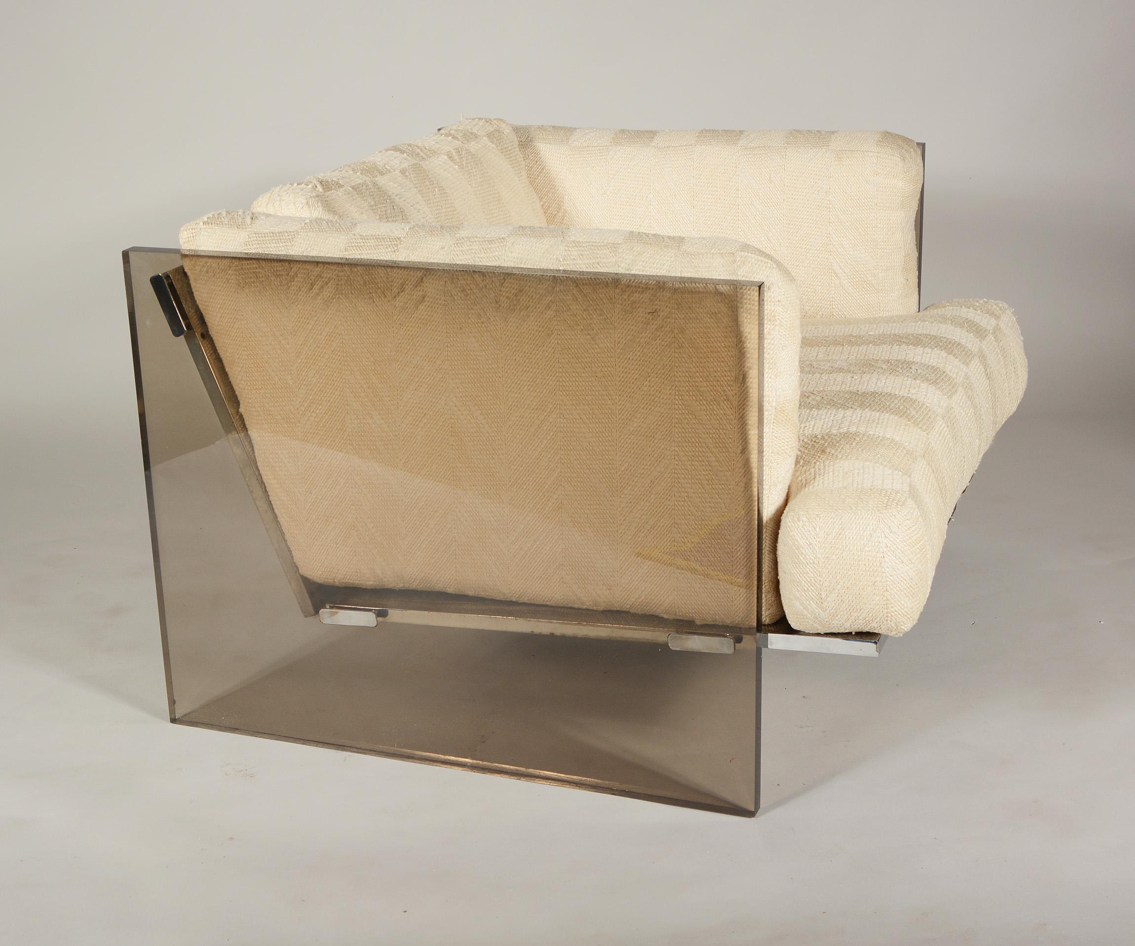 Lounge chair with slab smoked acrylic sides by Milo Baughman. This chair has a chrome frame with thick leather straps to support the cushions. The acrylic shows slight wear. There is a chip at the back bottom of one side and a small crack on the top