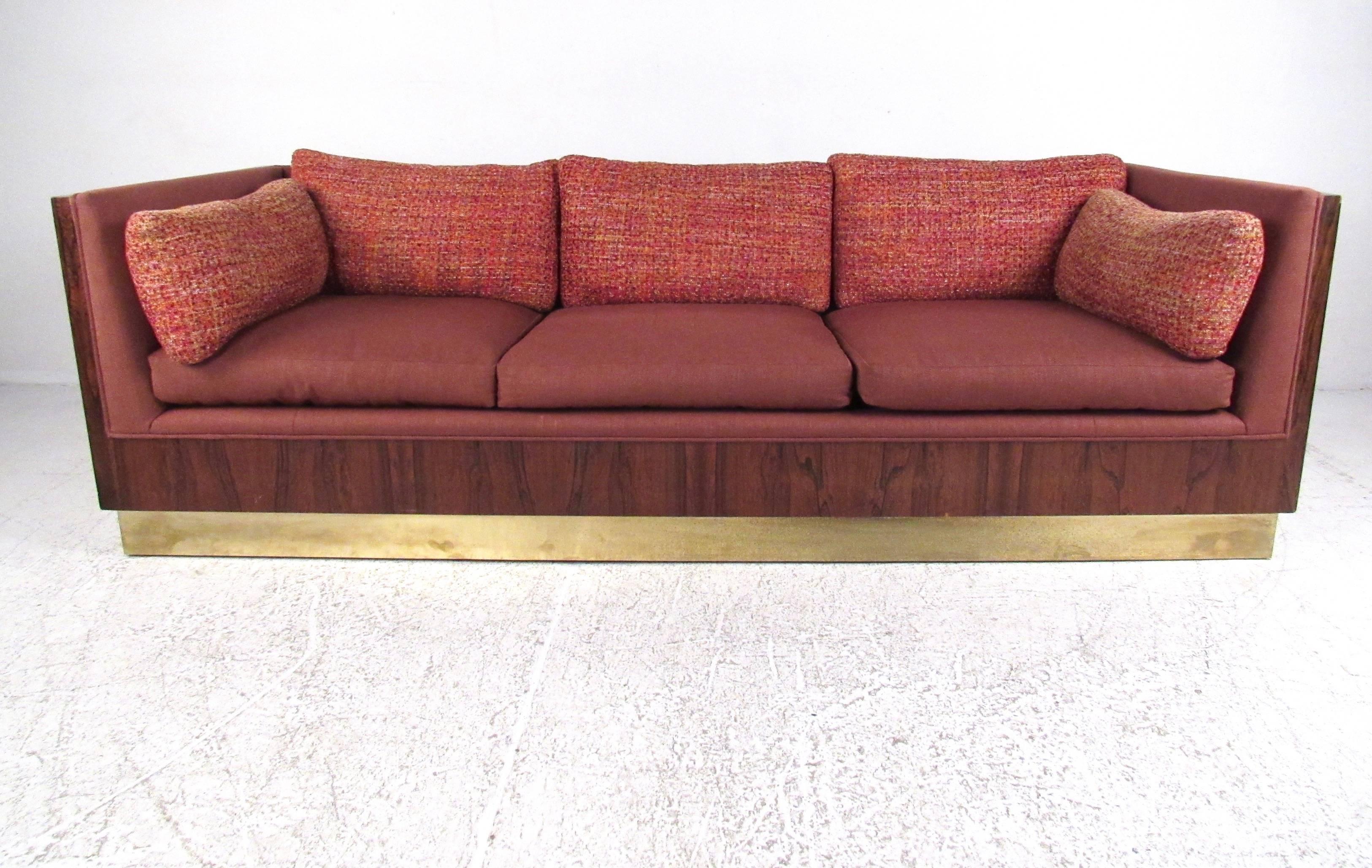 This stunning midcentury sofa by Milo Baughman features stylish vintage fabric, rich rosewood frame, and brass finish baseboard. Plush upholstered cushions feature unique two-tone covering, and makes an impressive statement in home or business