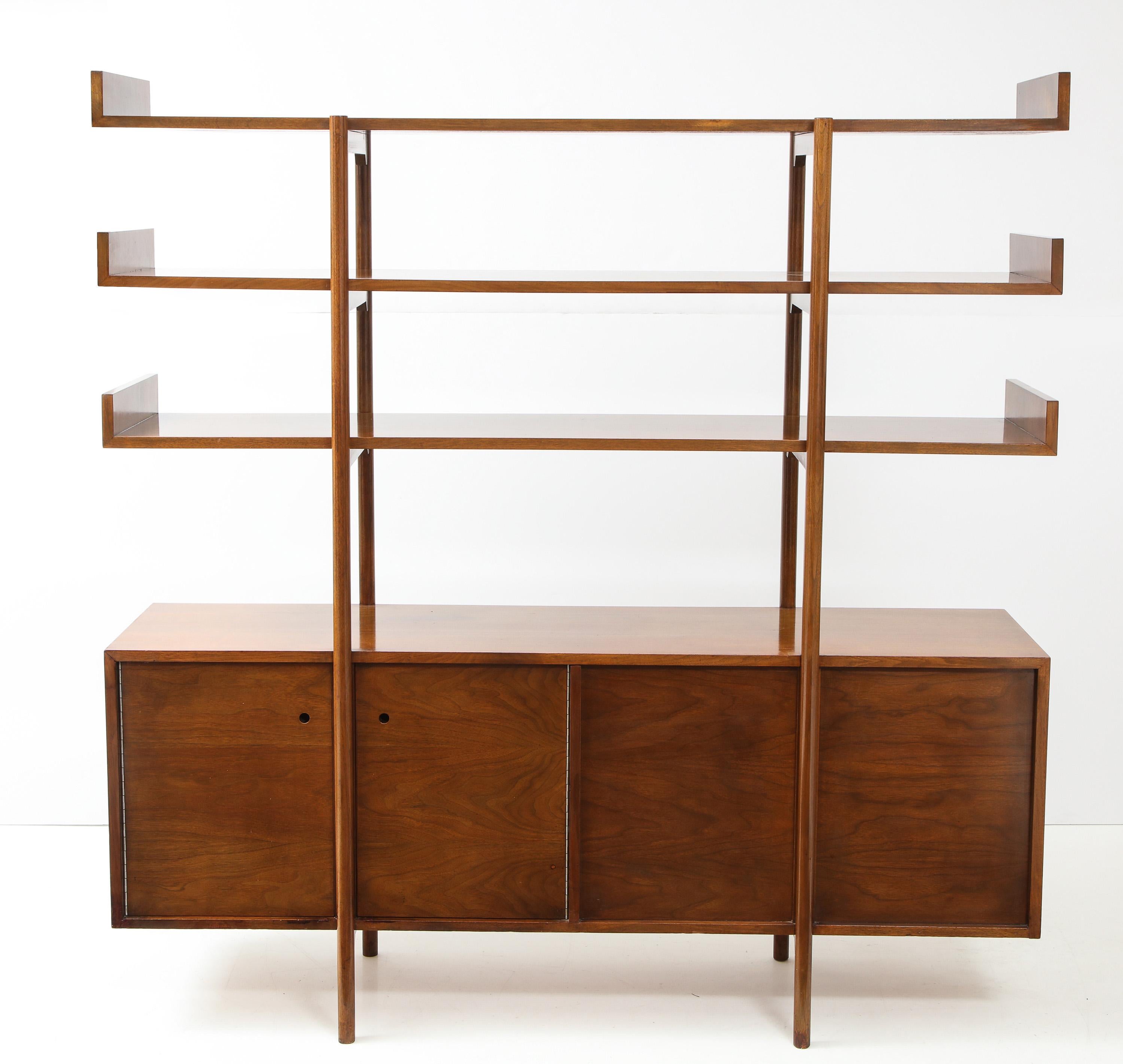 Divider or storage unit designed by Milo Baughman for Glenn of California, and produced, circa 1950. An early Baughman design suited to the purpose of dividing open-plan space. The case has doors that open on either side, with an adjustable shelf in