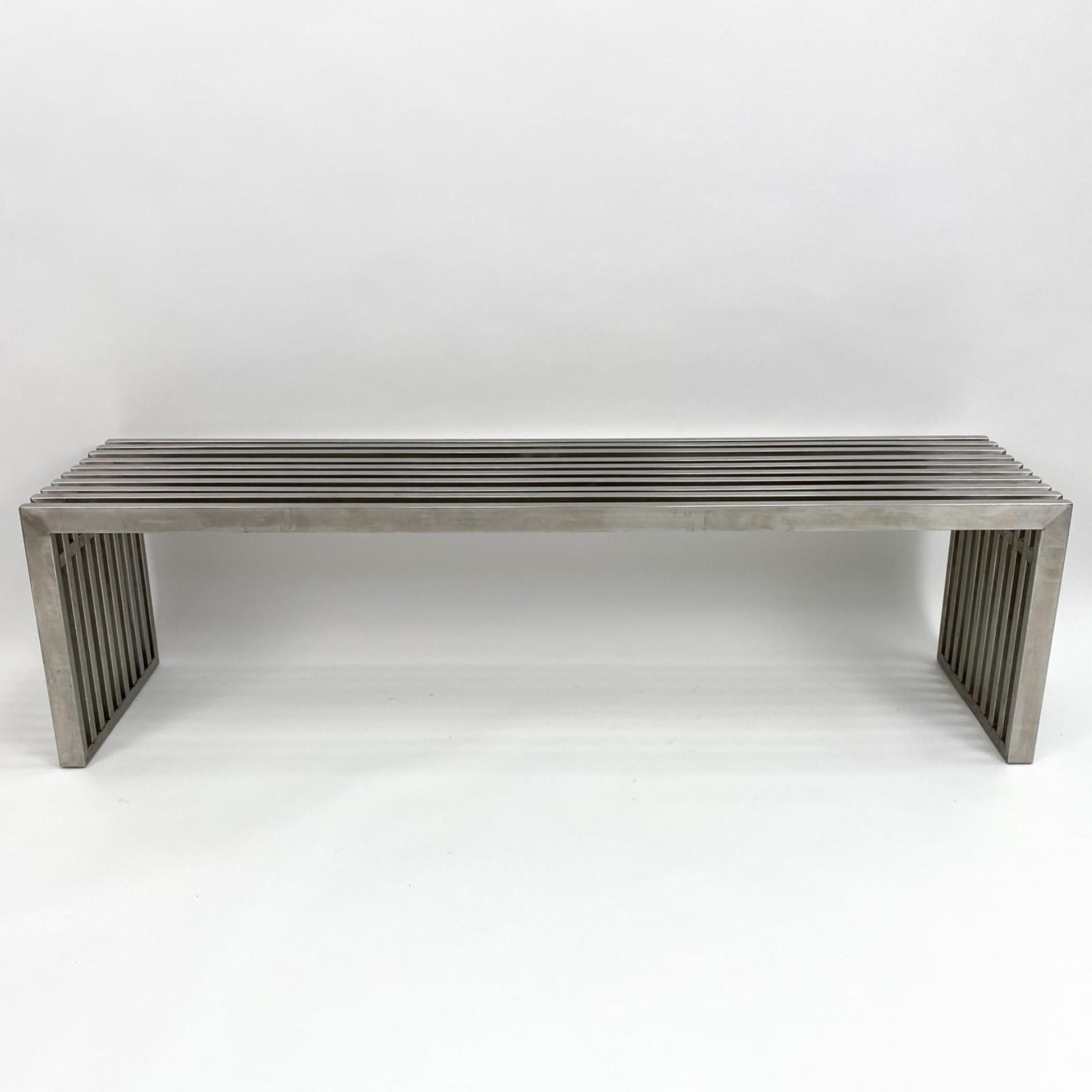 Sleek modernist metal slat bench in the manner of Milo Baughman. Chrome plated metal with metal spacers. The length of this bench measure 59