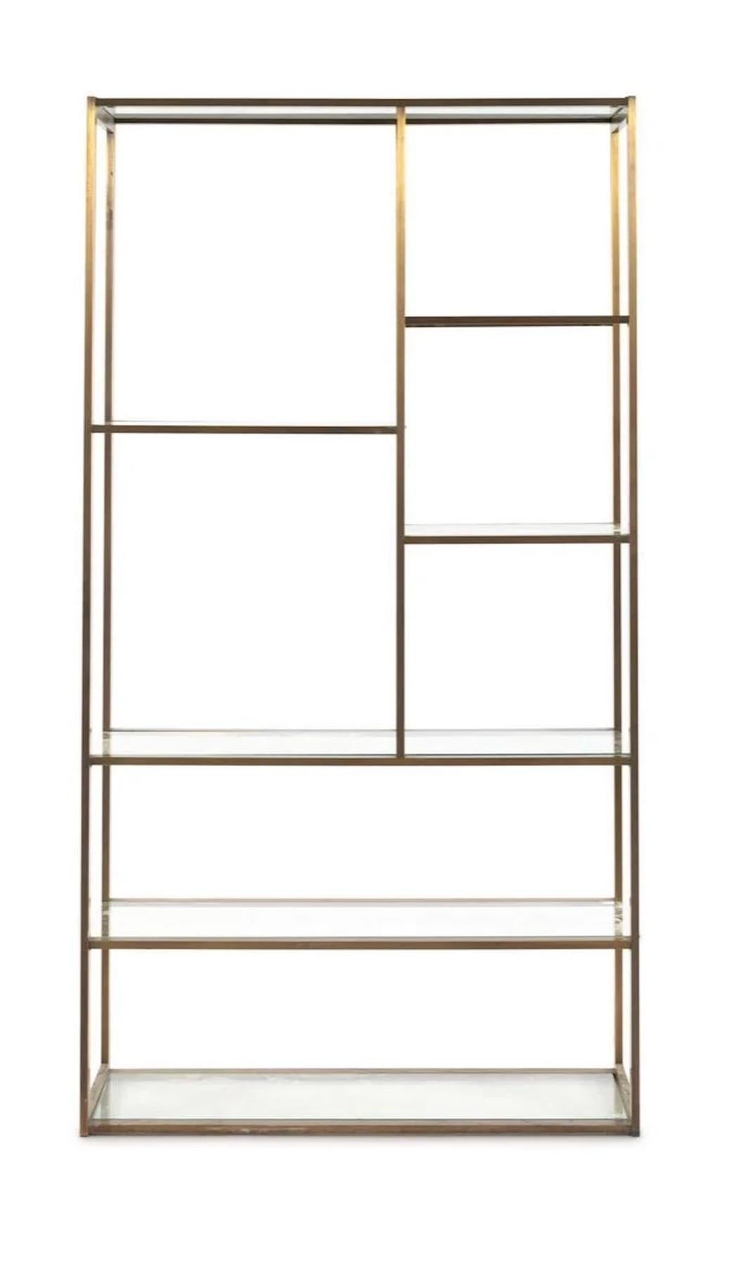 Handsome brass and glass étagère in the style of Milo Baughman. Versatile as can be used as a floating piece or against a wall.