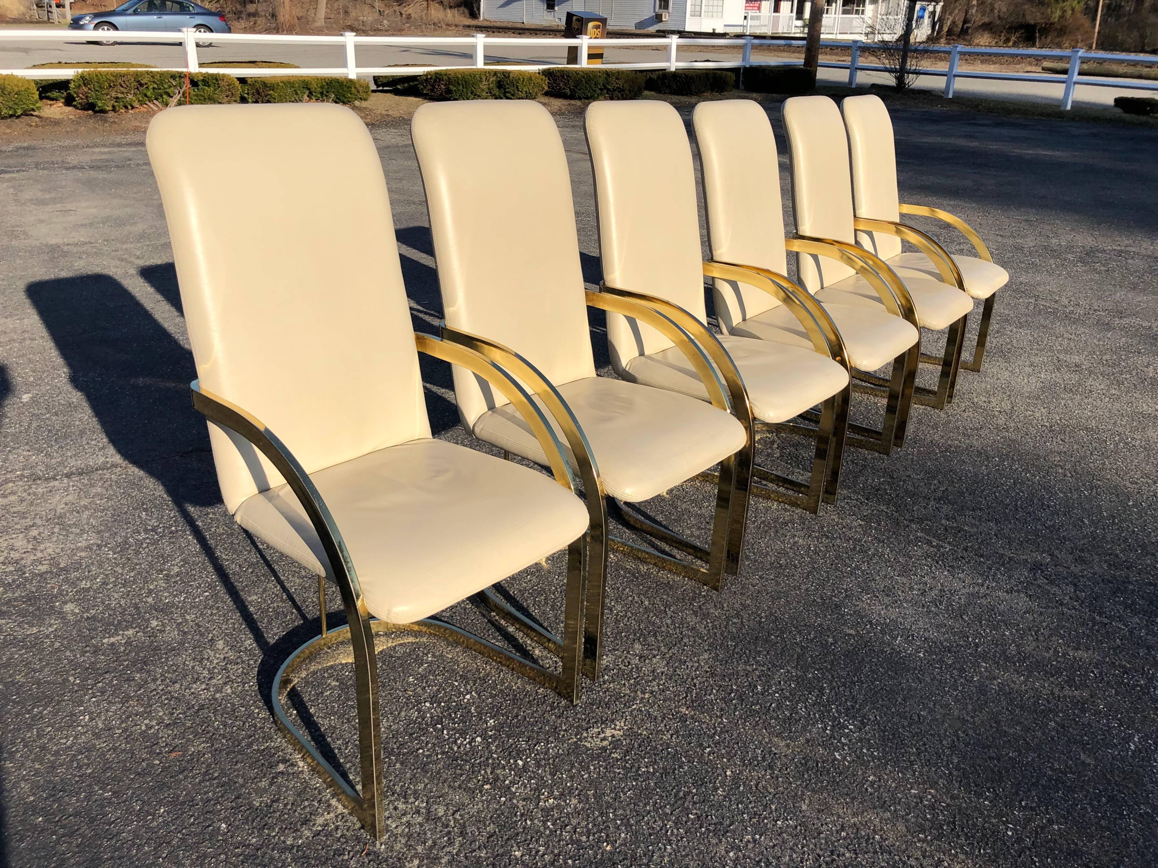 Milo Baughman style brass and leather set of chairs. Gorgeous from any angle these chairs are extremely comfortable and support with their high backs. Seat width is 18.75, seat depth is 18.50. The top of the arm rests are 26.75. Very good vintage